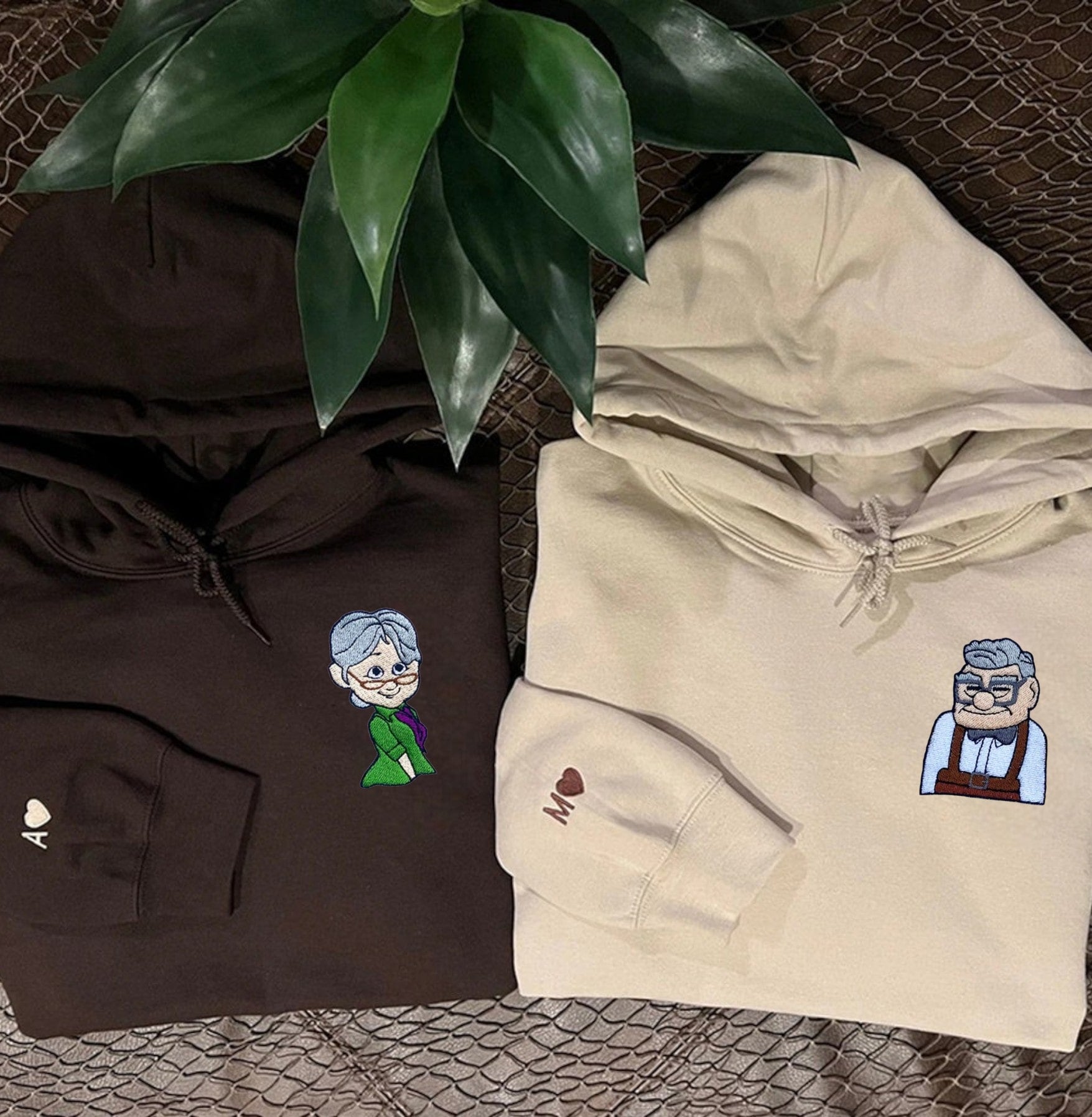 Charming couple hoodies featuring iconic older couple movie characters in brown and beige.