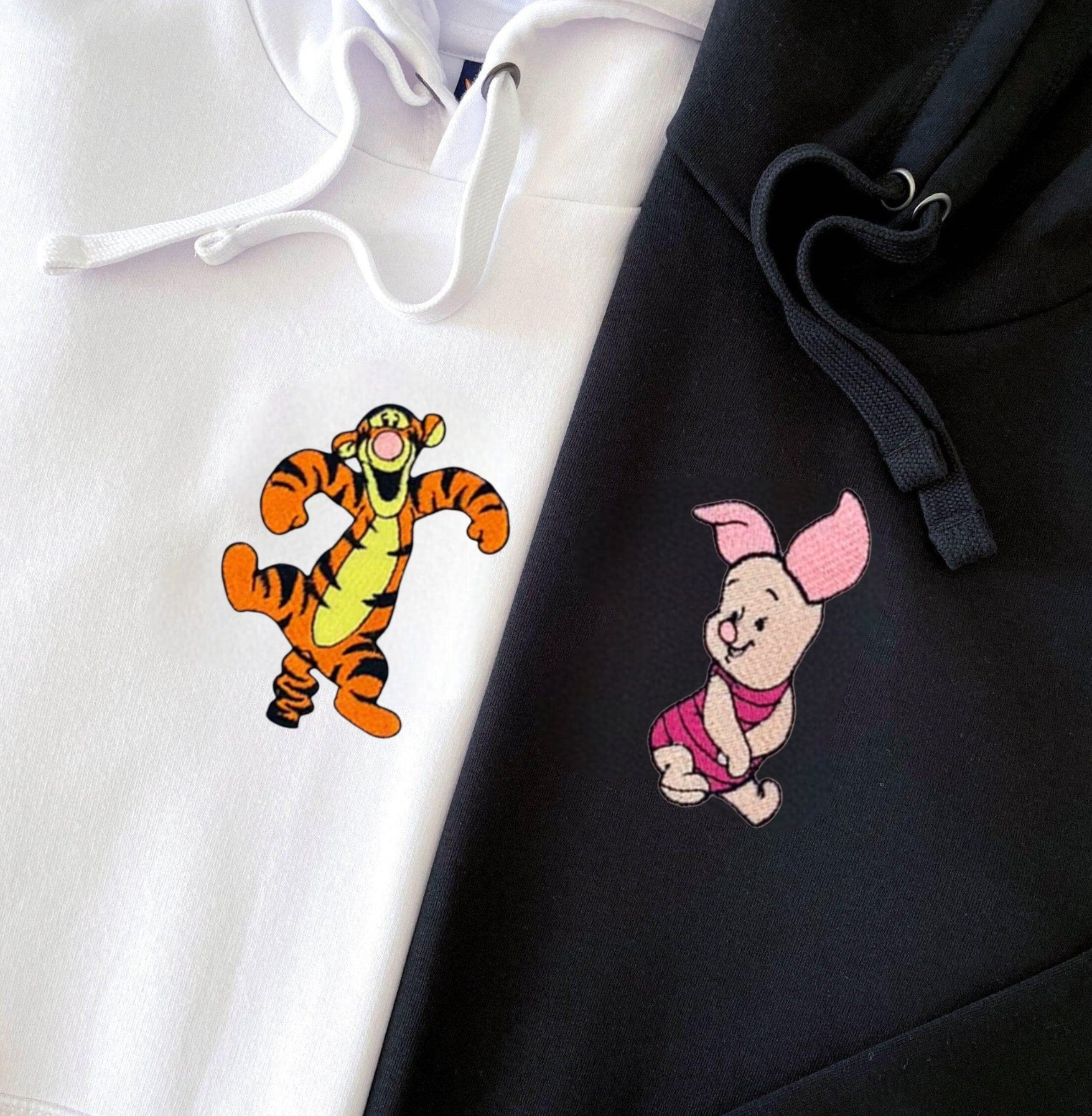 Matching couple hoodies with fun pig and tiger designs and personalized cuffs.