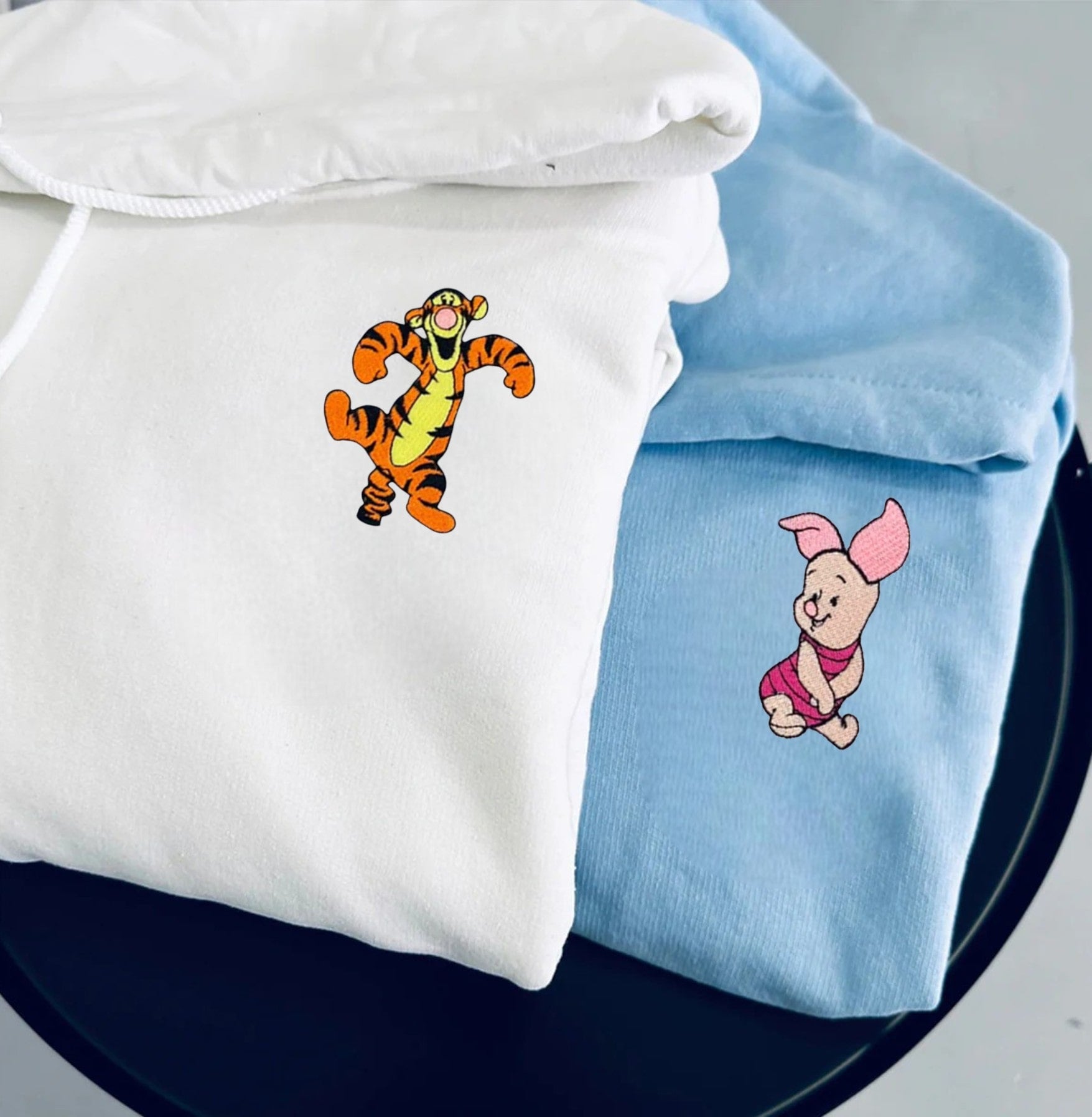 Cozy hoodies for couples with adorable embroidered pig and tiger characters.