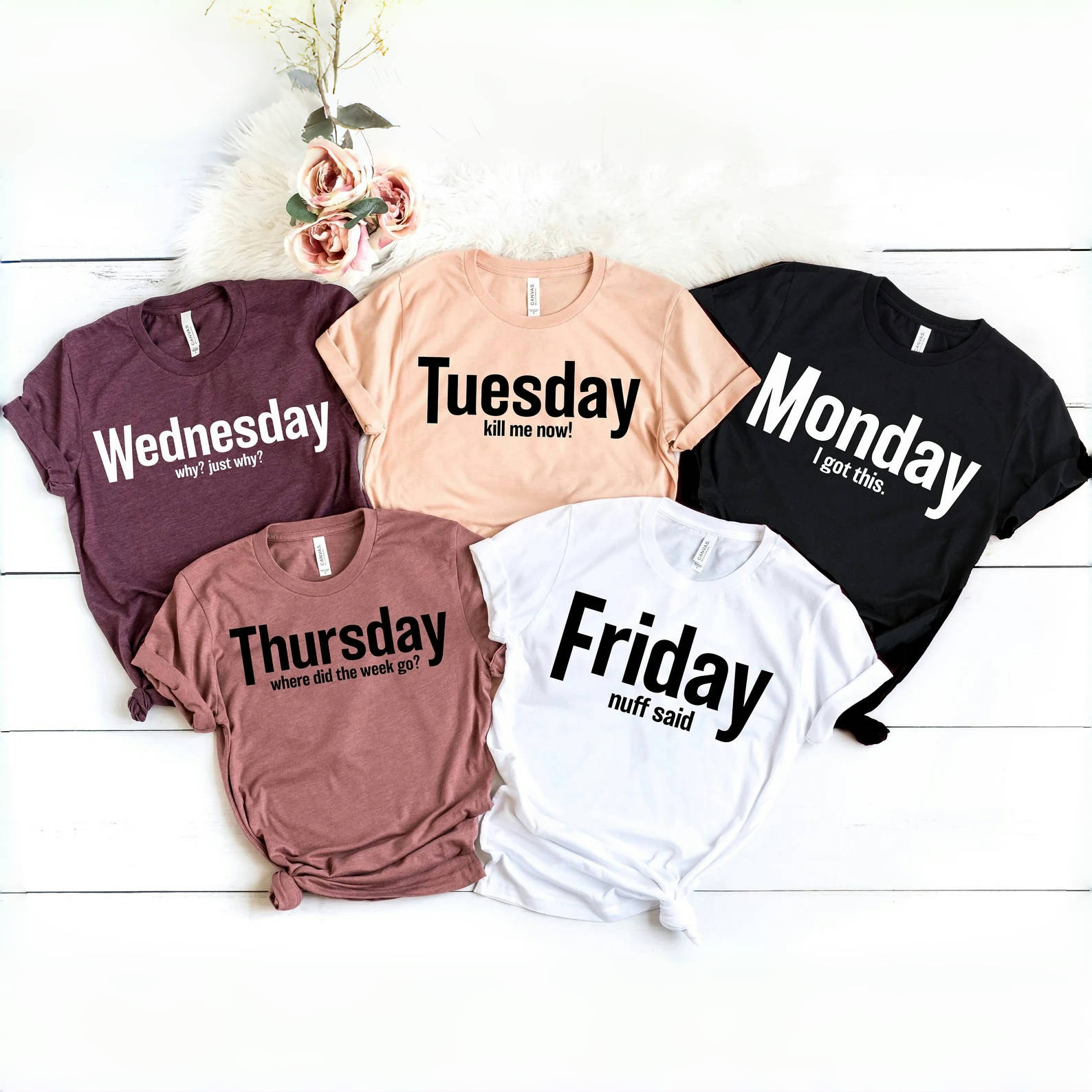 Set of five Days of the Week graphic tees featuring fun slogans for each day: Monday 'I got this', Tuesday 'kill me now!', Wednesday 'why? just why?', Thursday 'where did the week go?' and Friday 'nuff said'