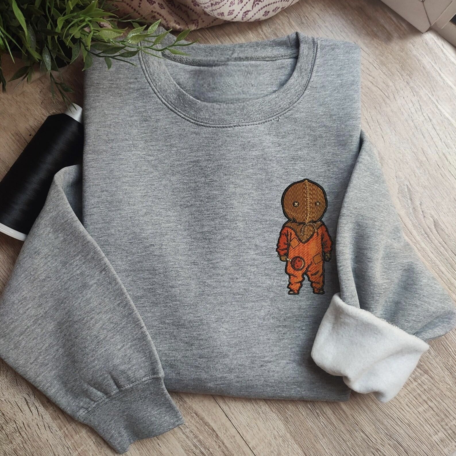 Custom embroidered graphic meme shirts highlighting a boy in orange footie pajamas, ideal for lovers of funny meme shirts.
