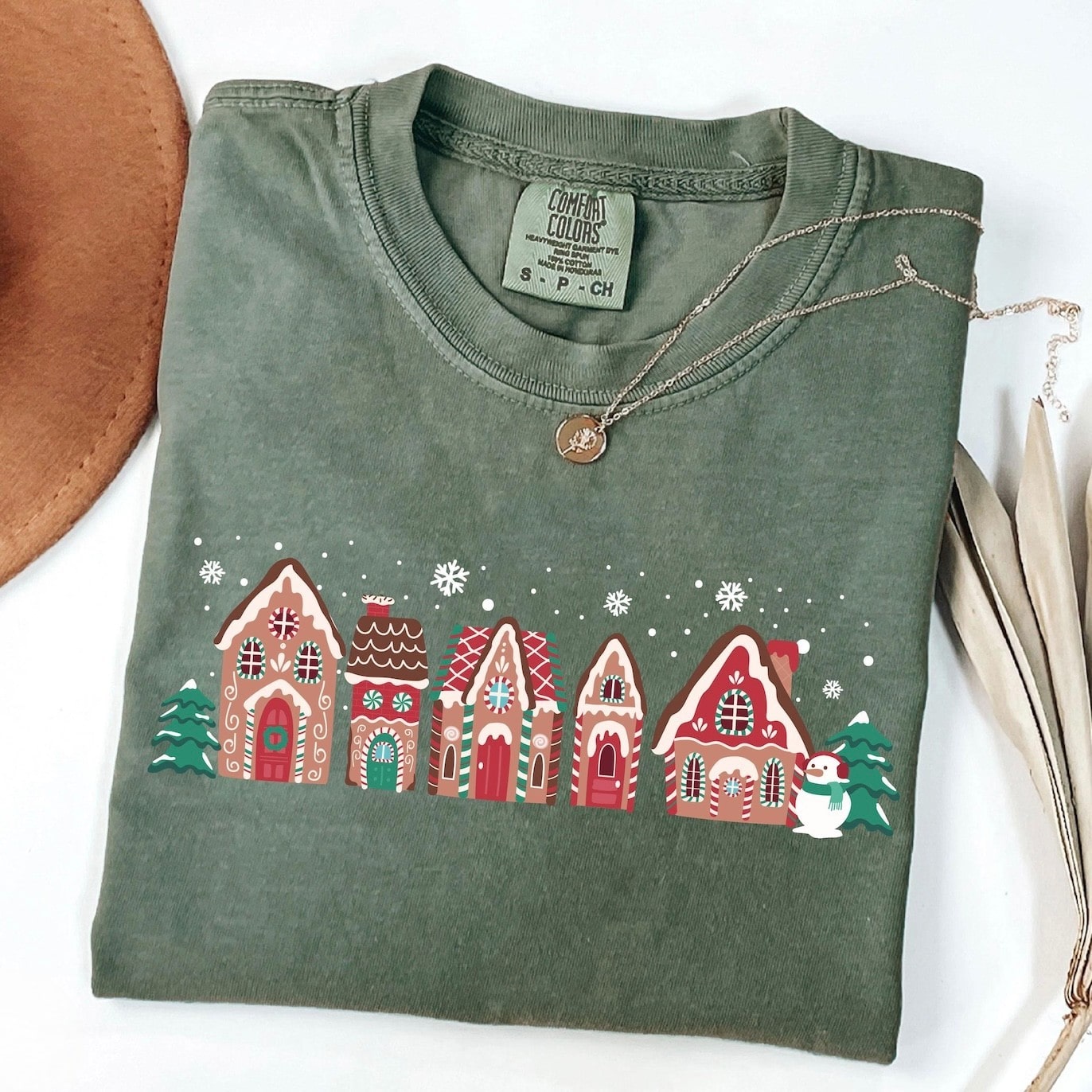 Holiday-themed sweatshirt with a charming gingerbread village print
