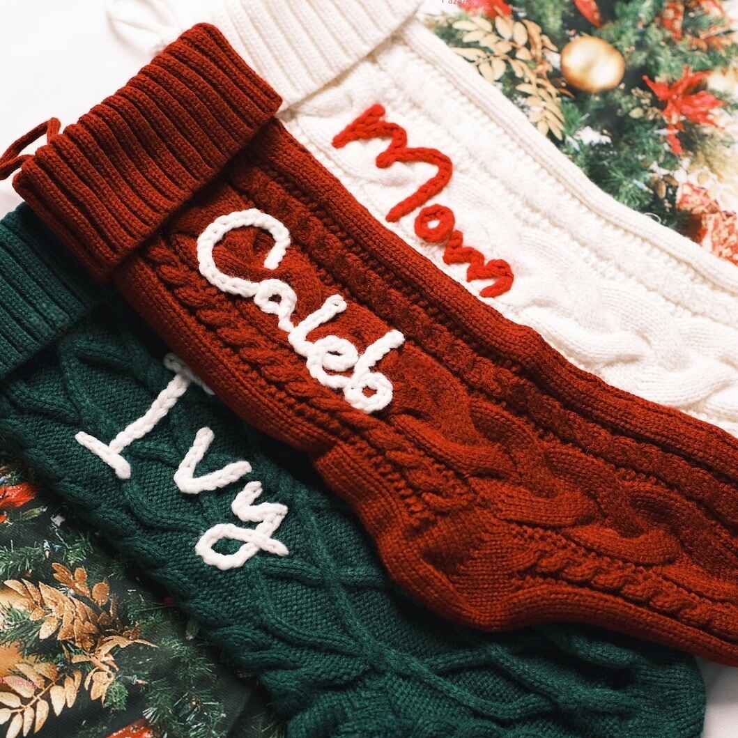 Festive Christmas stockings with names in red, green, and cream
