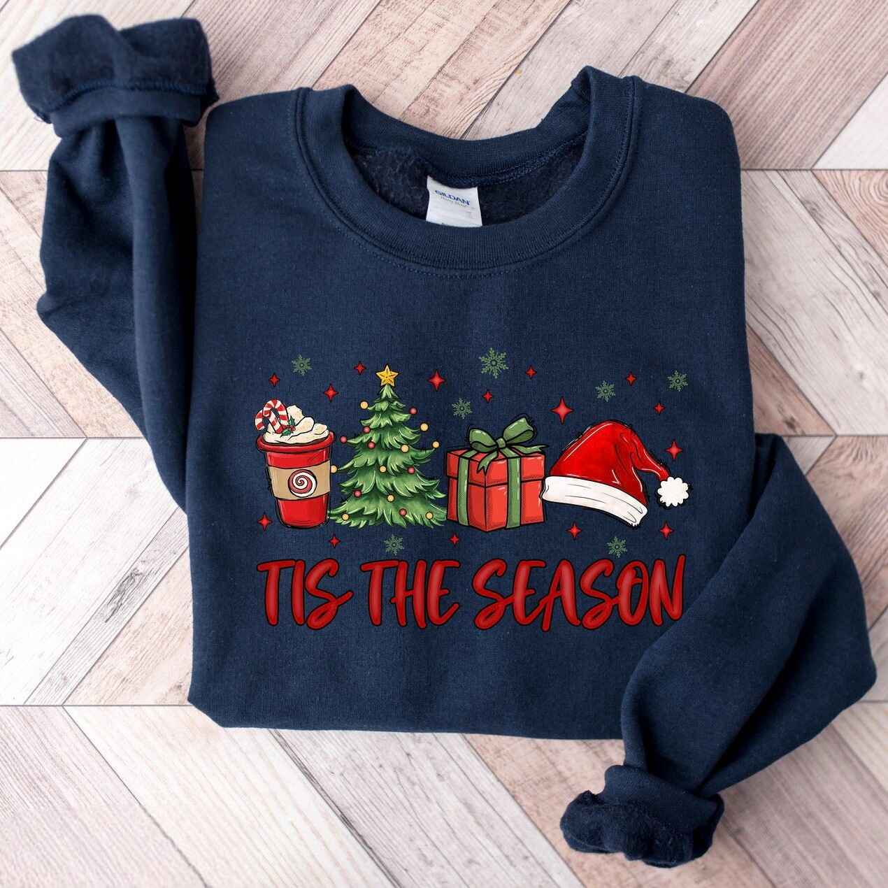 Cozy Christmas sweatshirt featuring Christmas tree, gifts, and Santa hat
