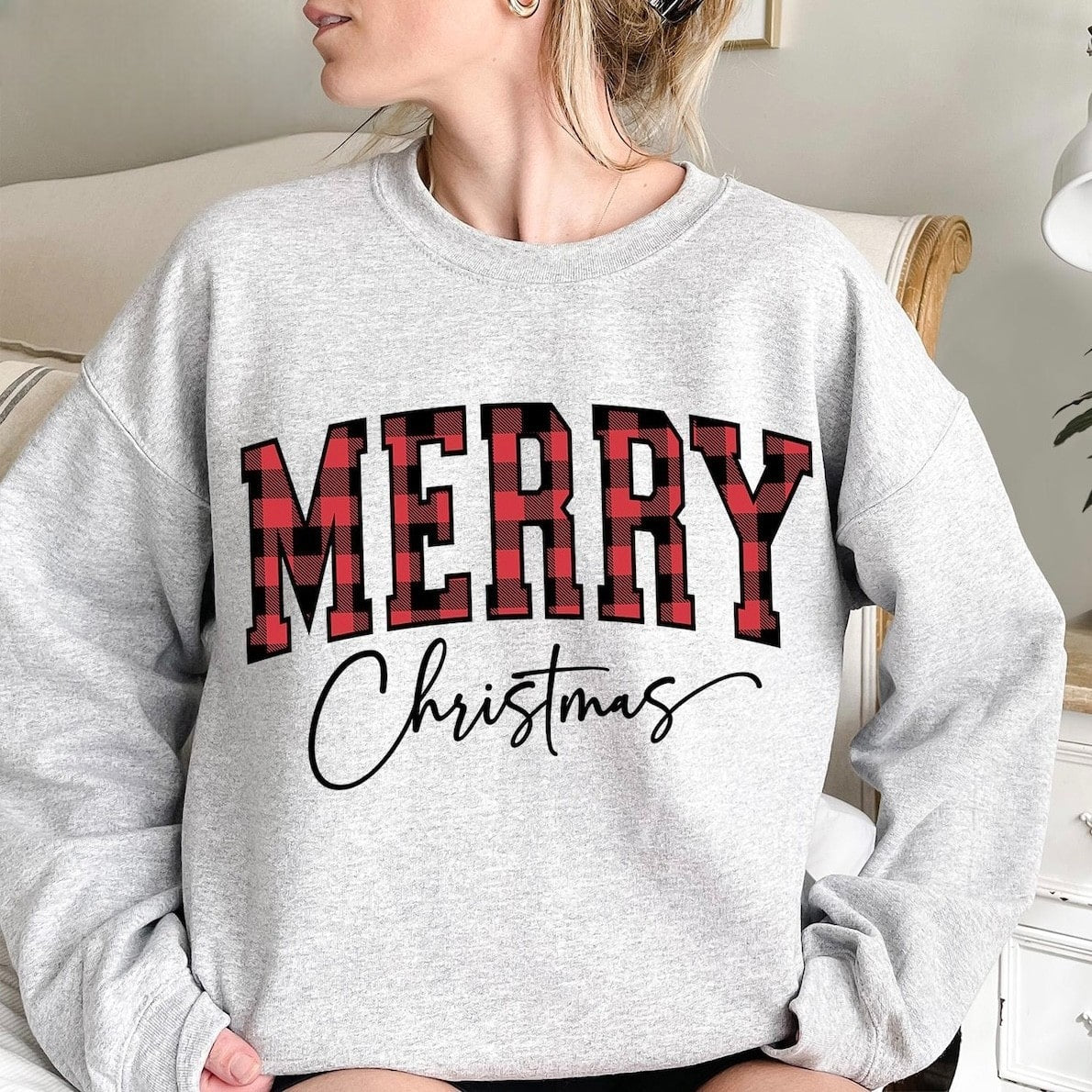 Cozy Christmas sweatshirt featuring festive plaid lettering
