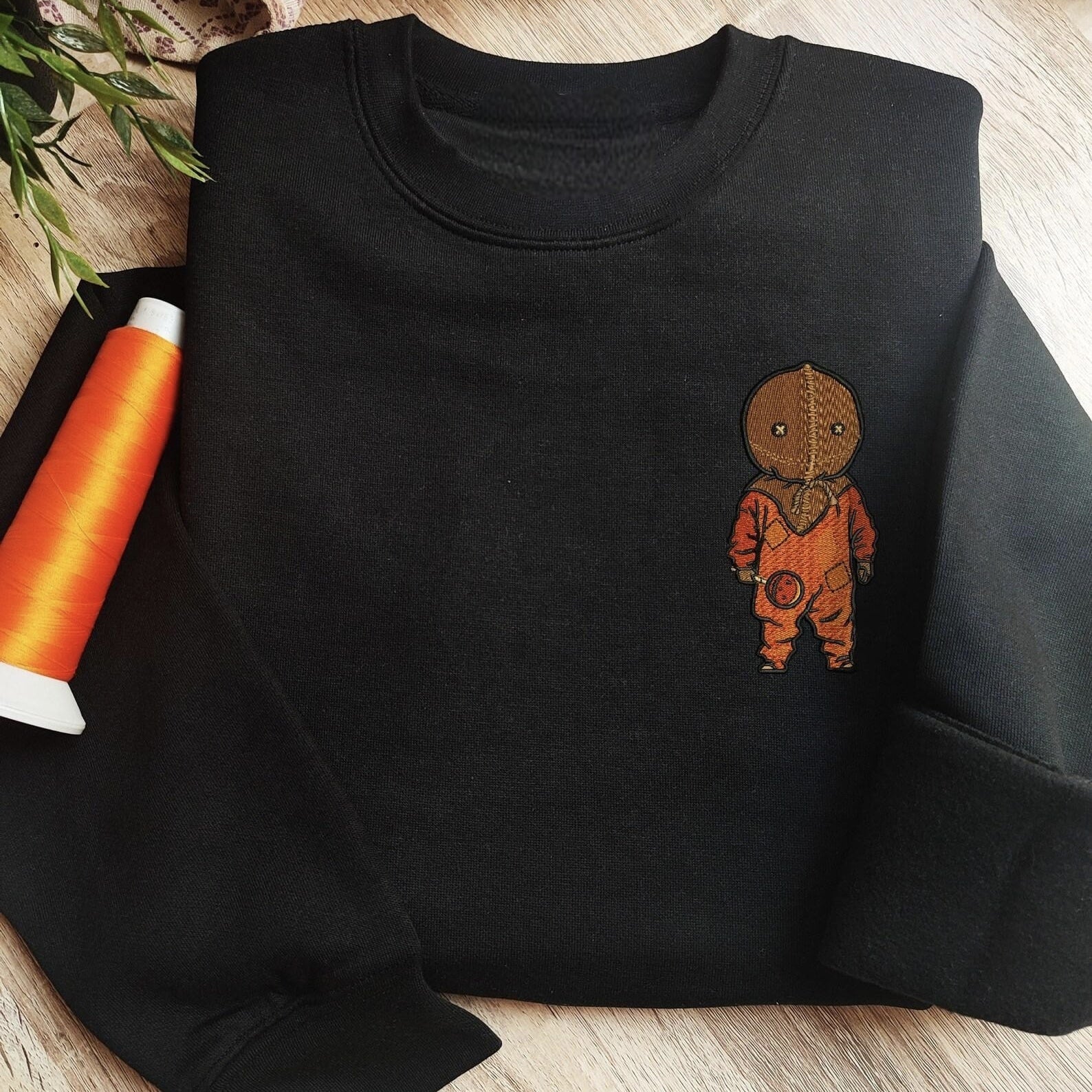 Custom embroidered graphic meme shirts showcasing a quirky boy in orange footie pajamas on a grey hoodie, perfect for fans of funny meme t-shirts.
