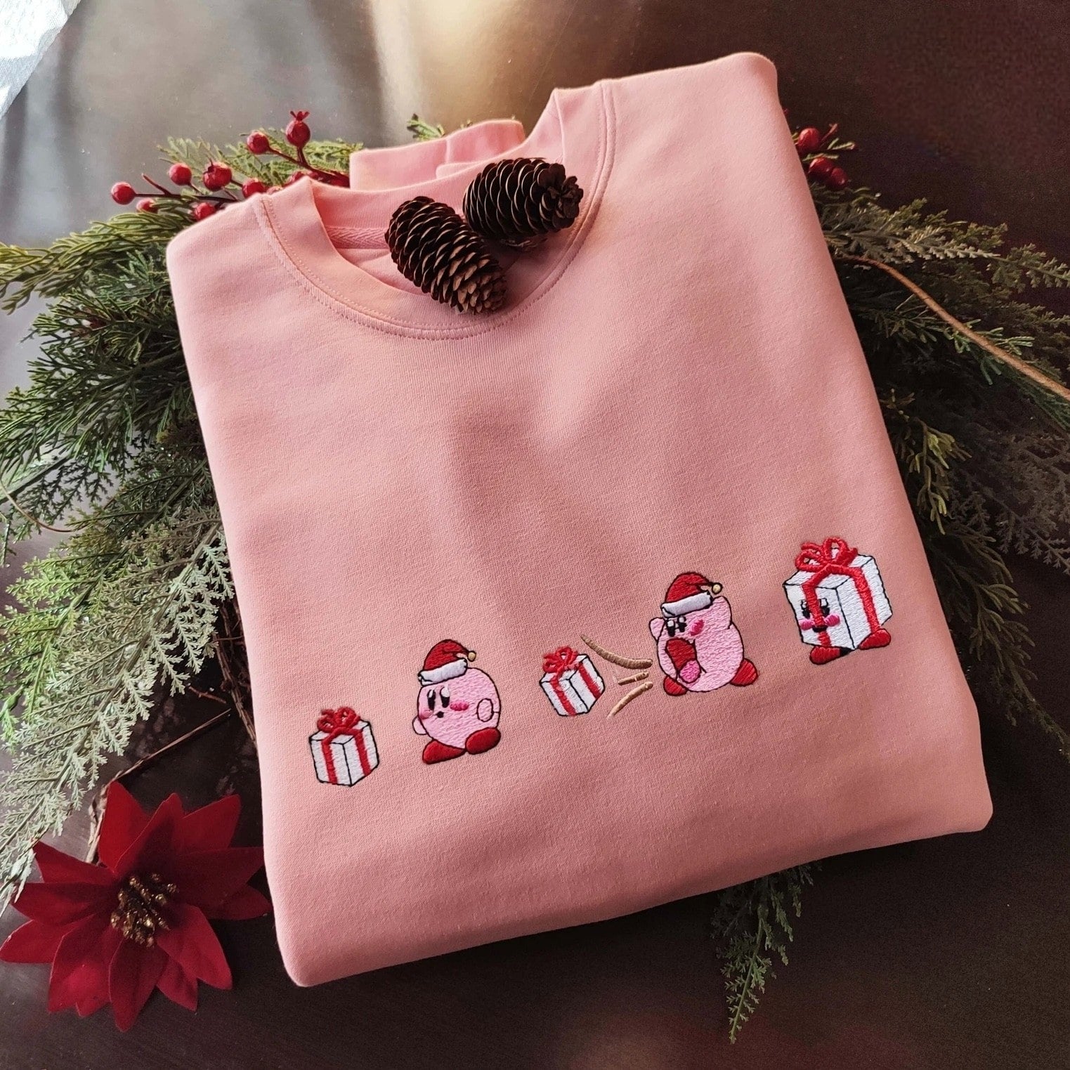 Custom embroidered graphic meme shirts with a holiday theme, capturing a t-shirt meme with festive character embroidery.
