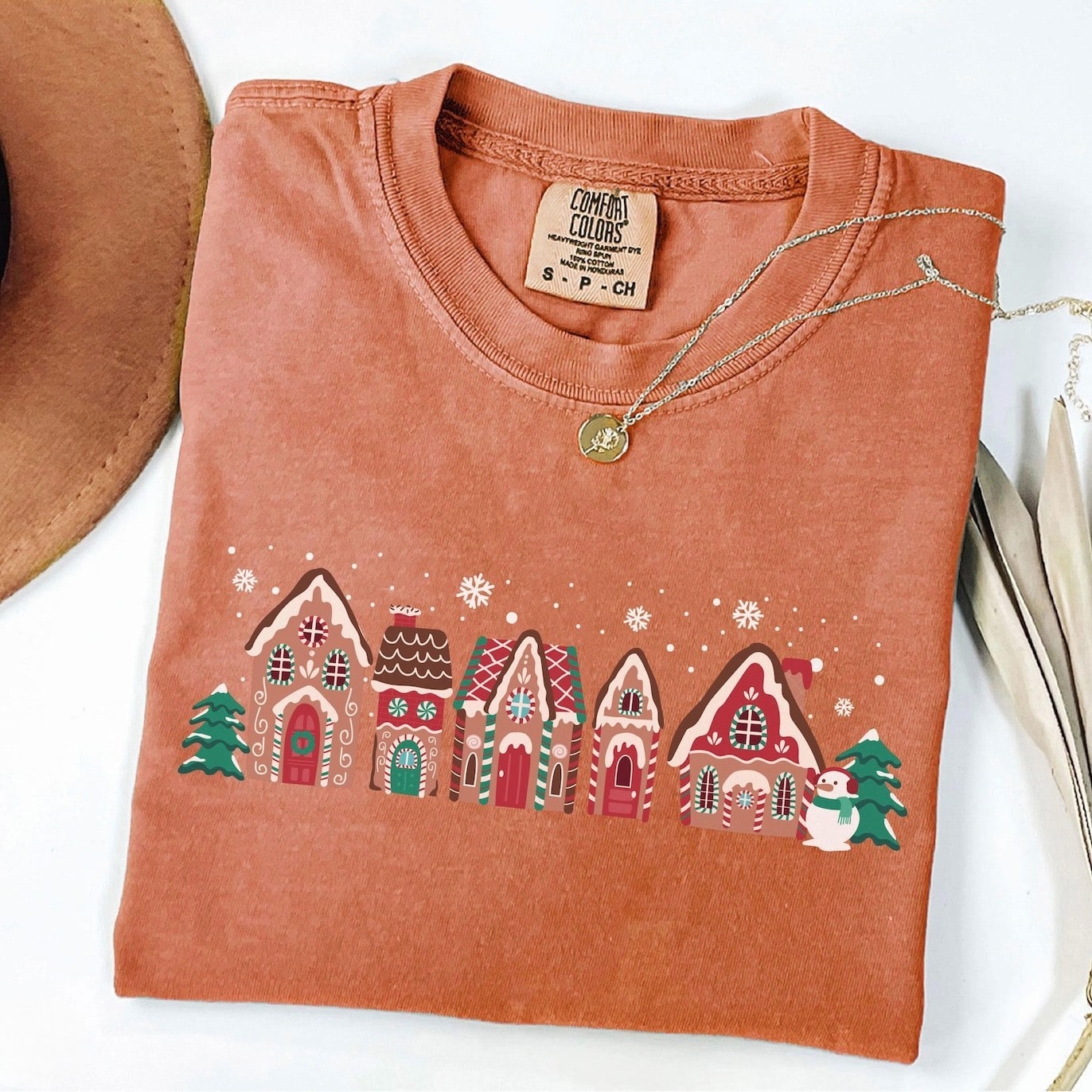 Holiday-themed sweatshirt with a charming gingerbread village print
