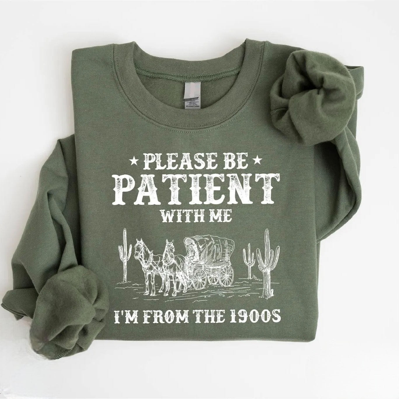 Close-up of "Please Be Patient with Me" shirt with vintage graphics.
