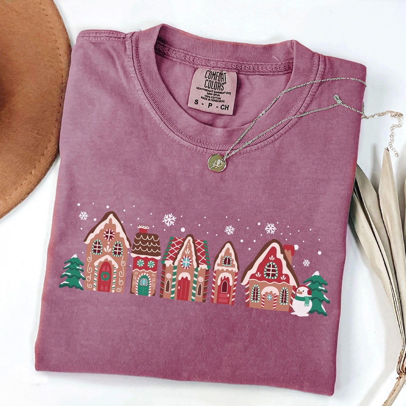 Cozy sweatshirt featuring festive gingerbread houses and snowflakes
