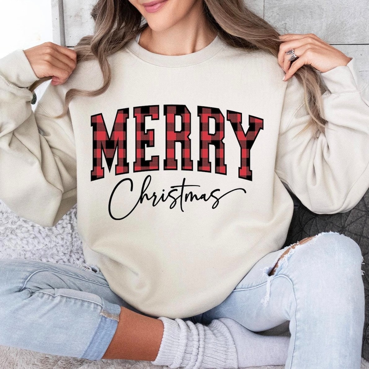 Cozy Christmas sweatshirt featuring festive plaid lettering
