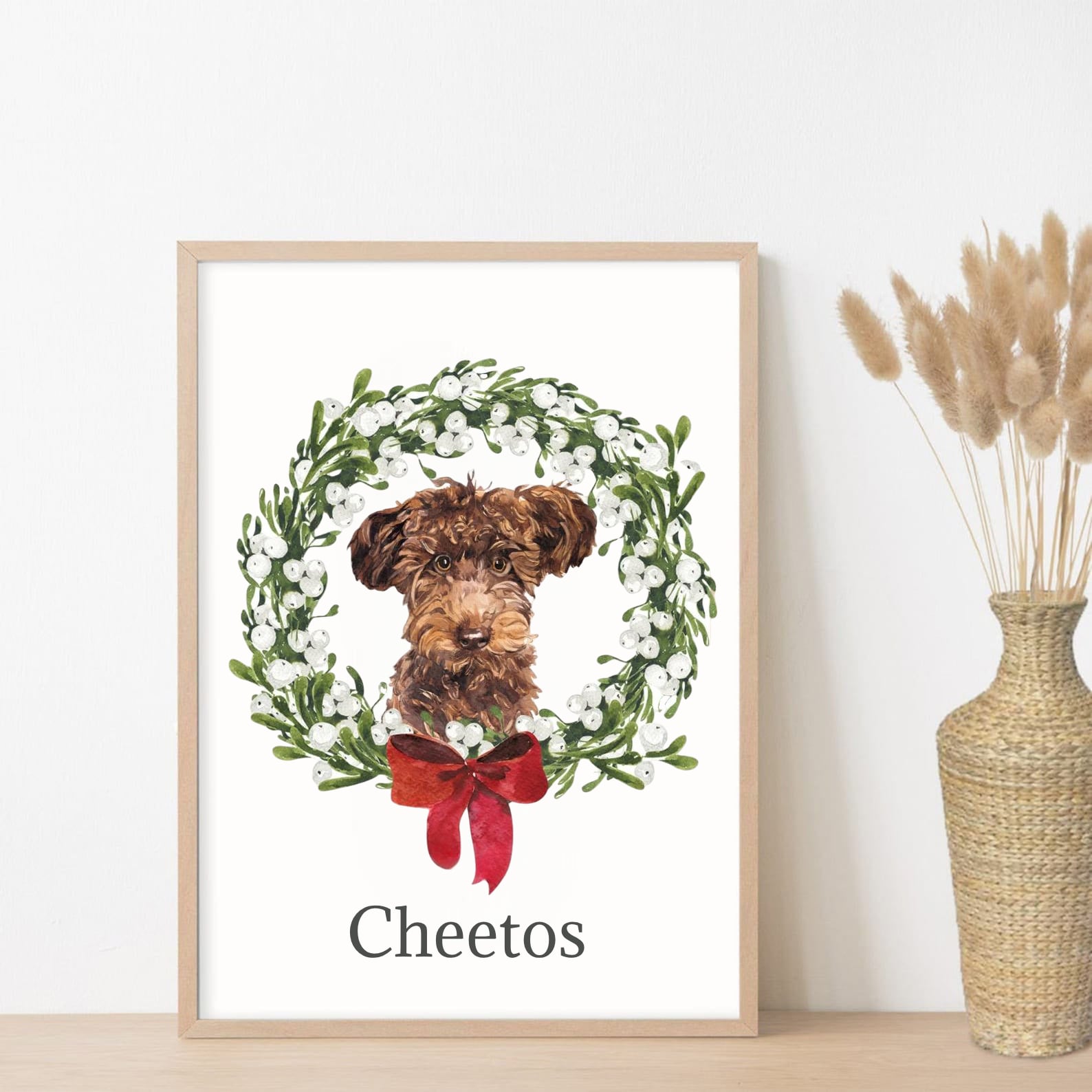 Custom dog portrait wreath print with green foliage and red bow, named "Cheetos"

