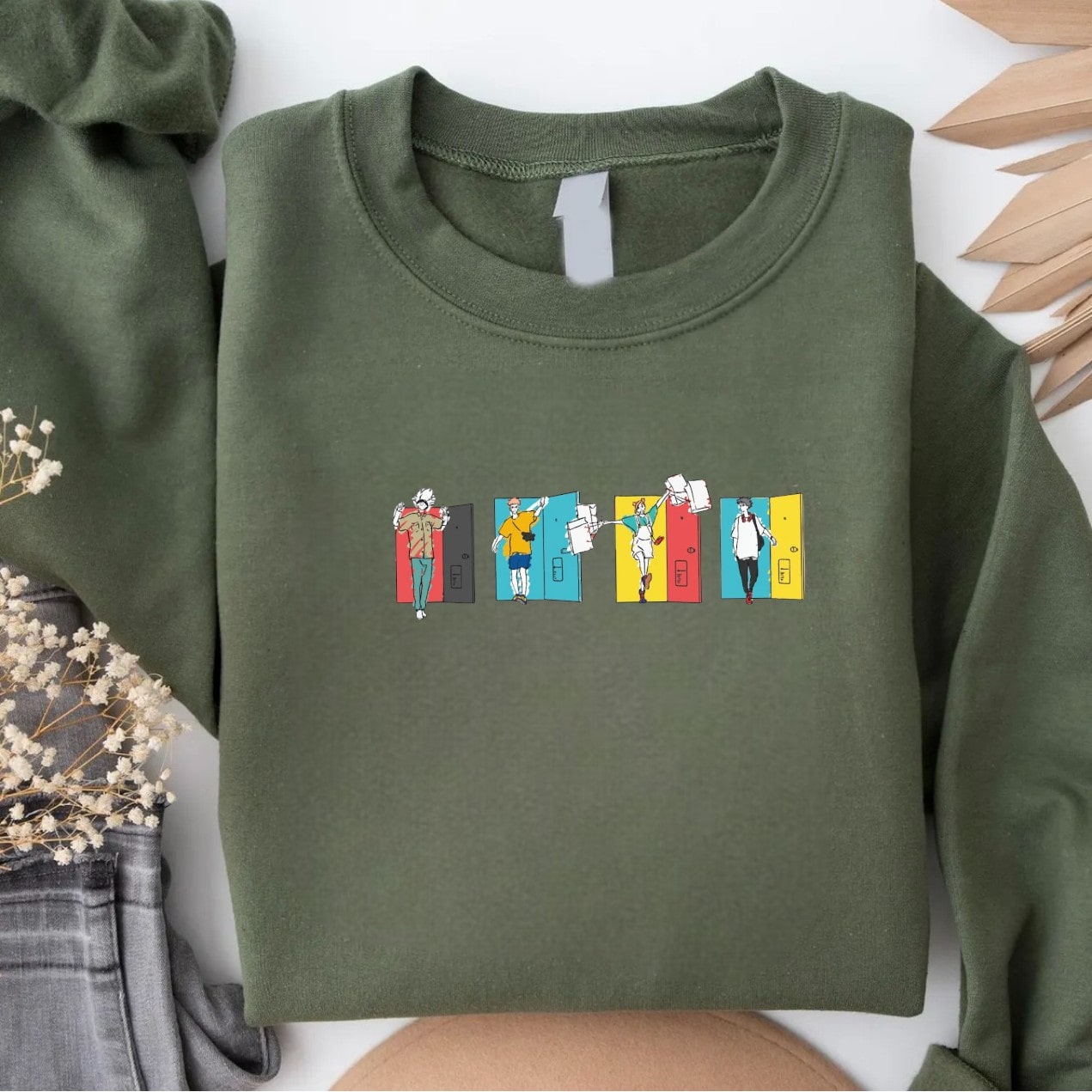 Olive-green sweatshirt featuring colorful anime door graphics.
