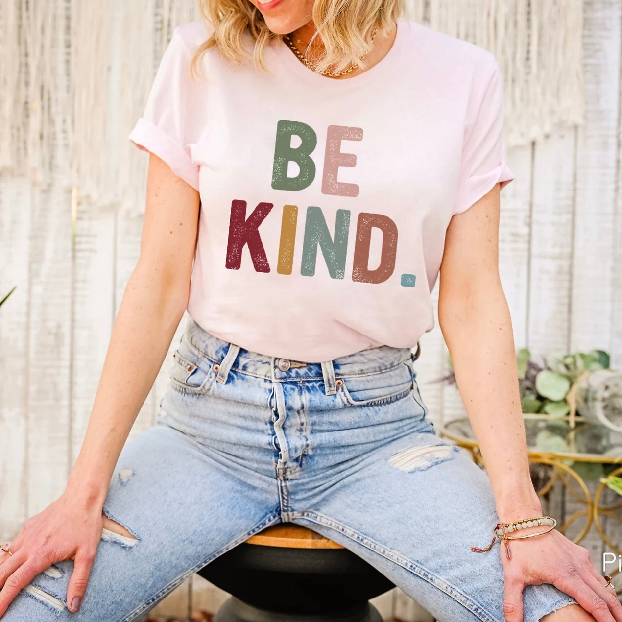 Pink "Be Kind" graphic tee with colorful lettering.