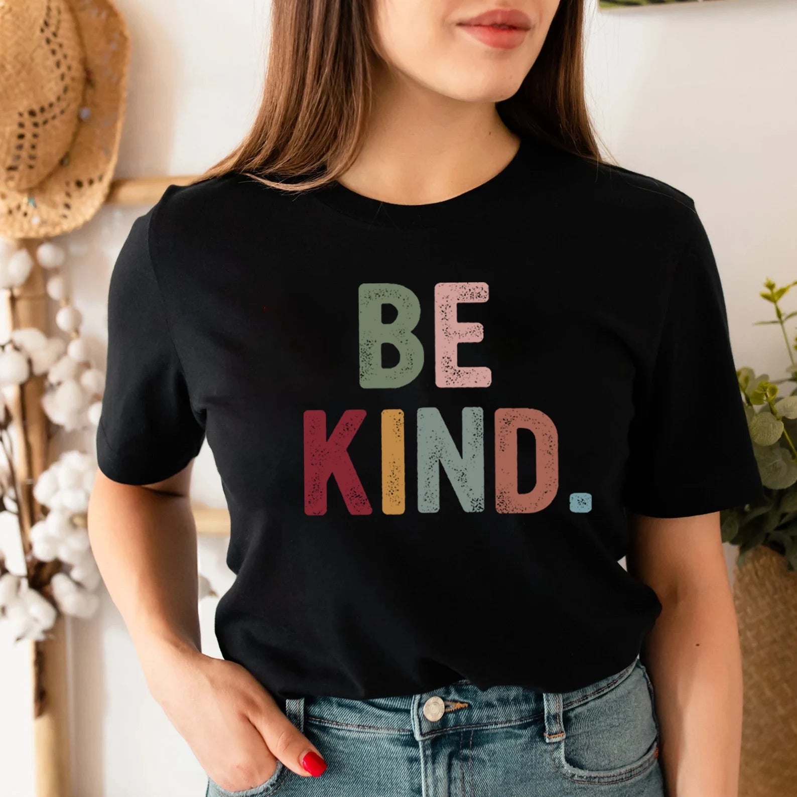 Black "Be Kind" tee worn with denim and styled casually.