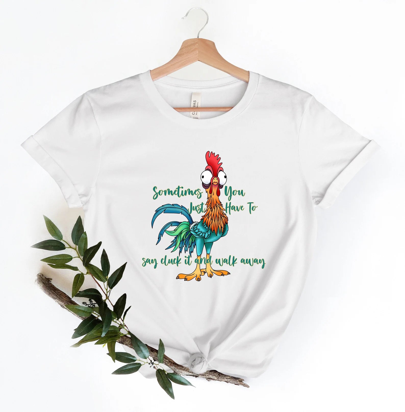 White tee with playful rooster illustration and humorous text.