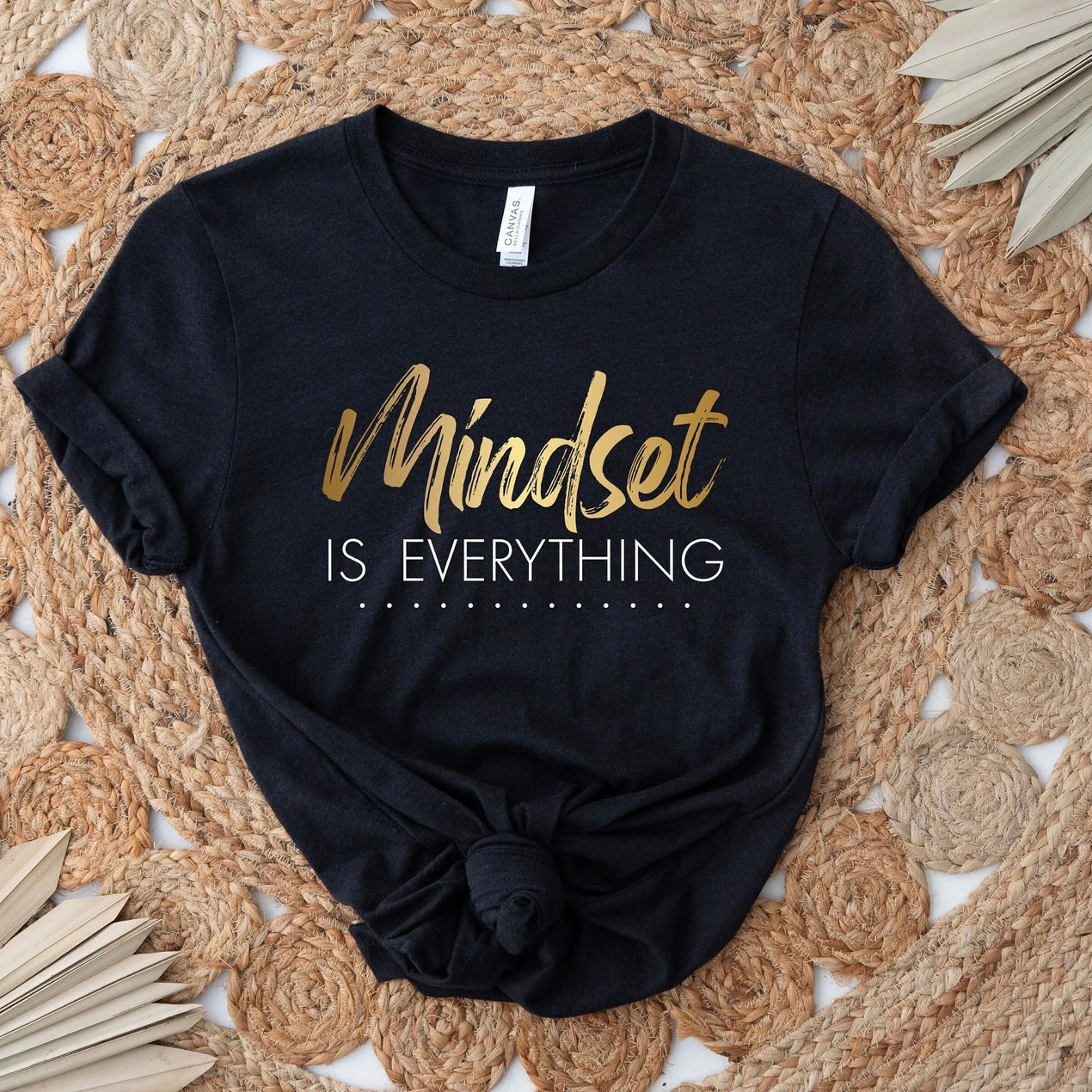 Black "Mindset is Everything" t-shirt on woven surface