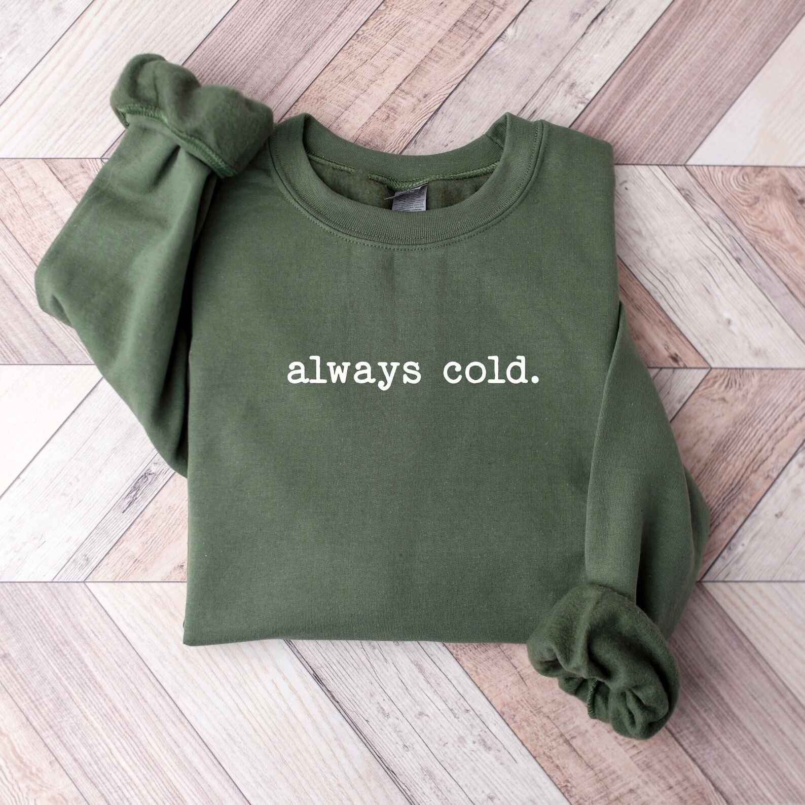 Humorous winter sweatshirt with "Always Cold" text
