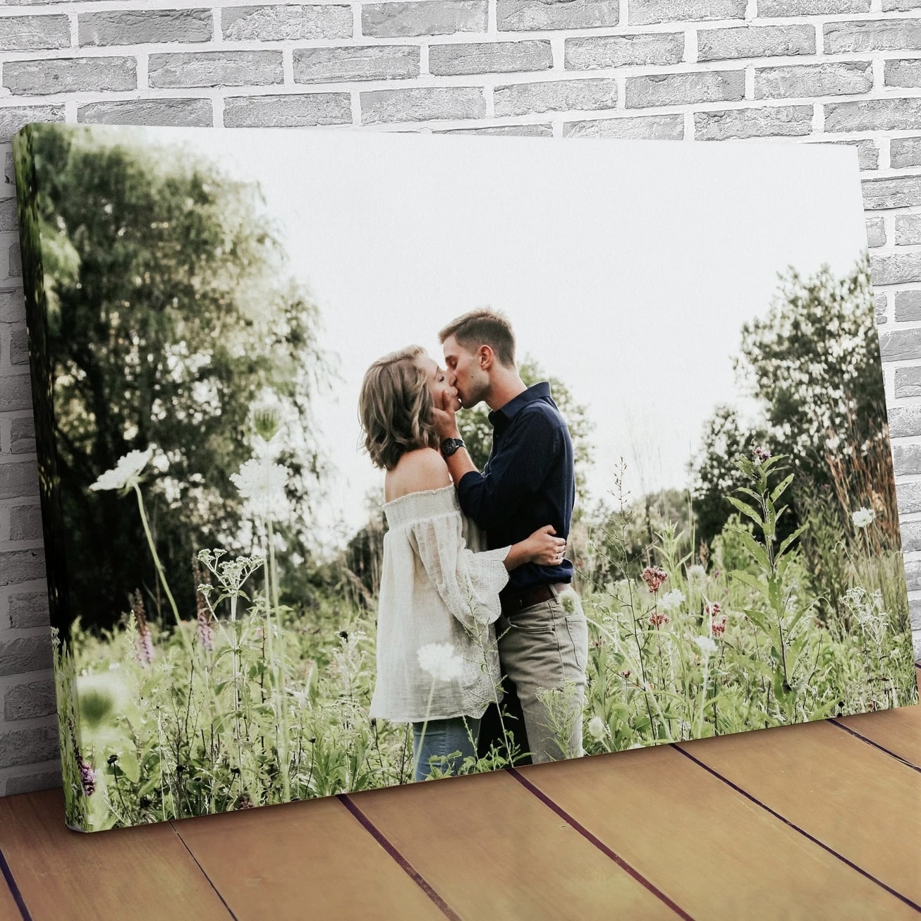 High-quality custom photo canvas displayed against a brick wall.