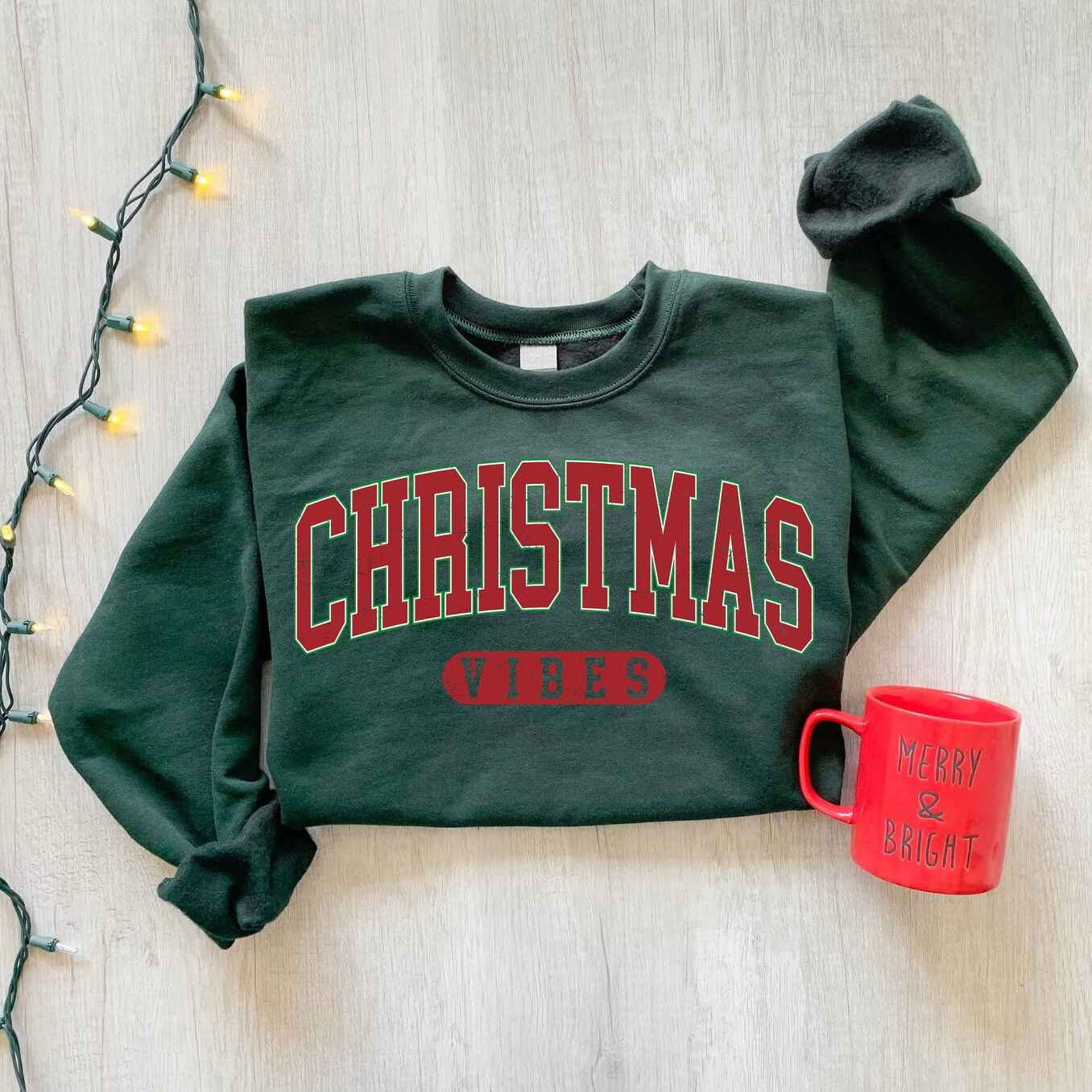 Cozy Christmas Vibes sweatshirt with festive red and green lettering
