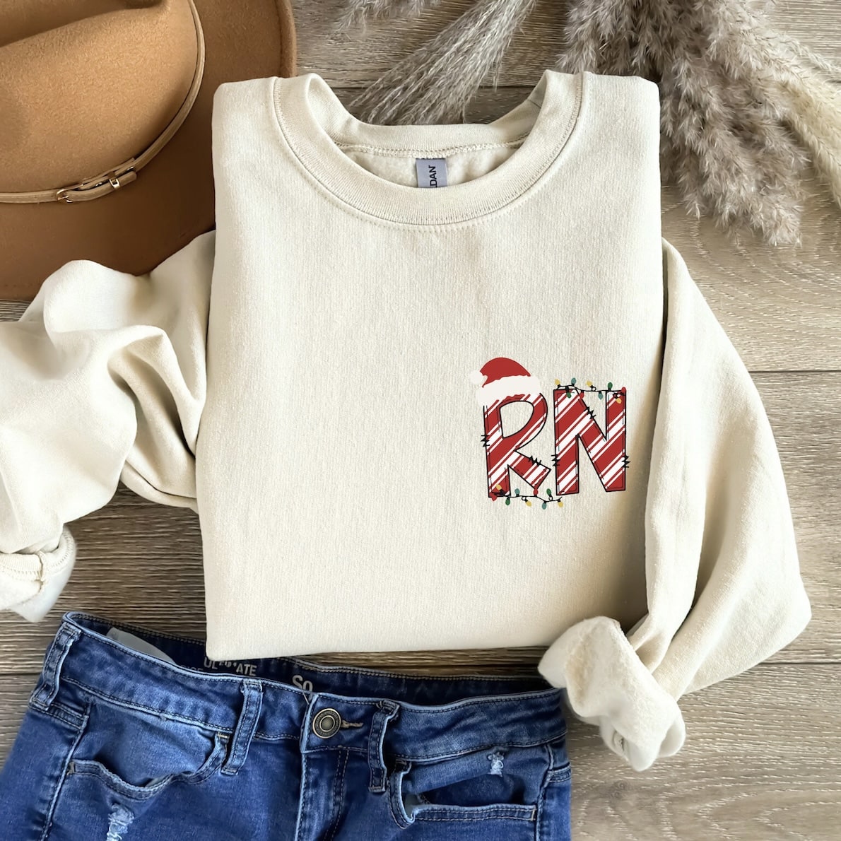 Cream sweatshirt with RN candy cane design and Santa hat
