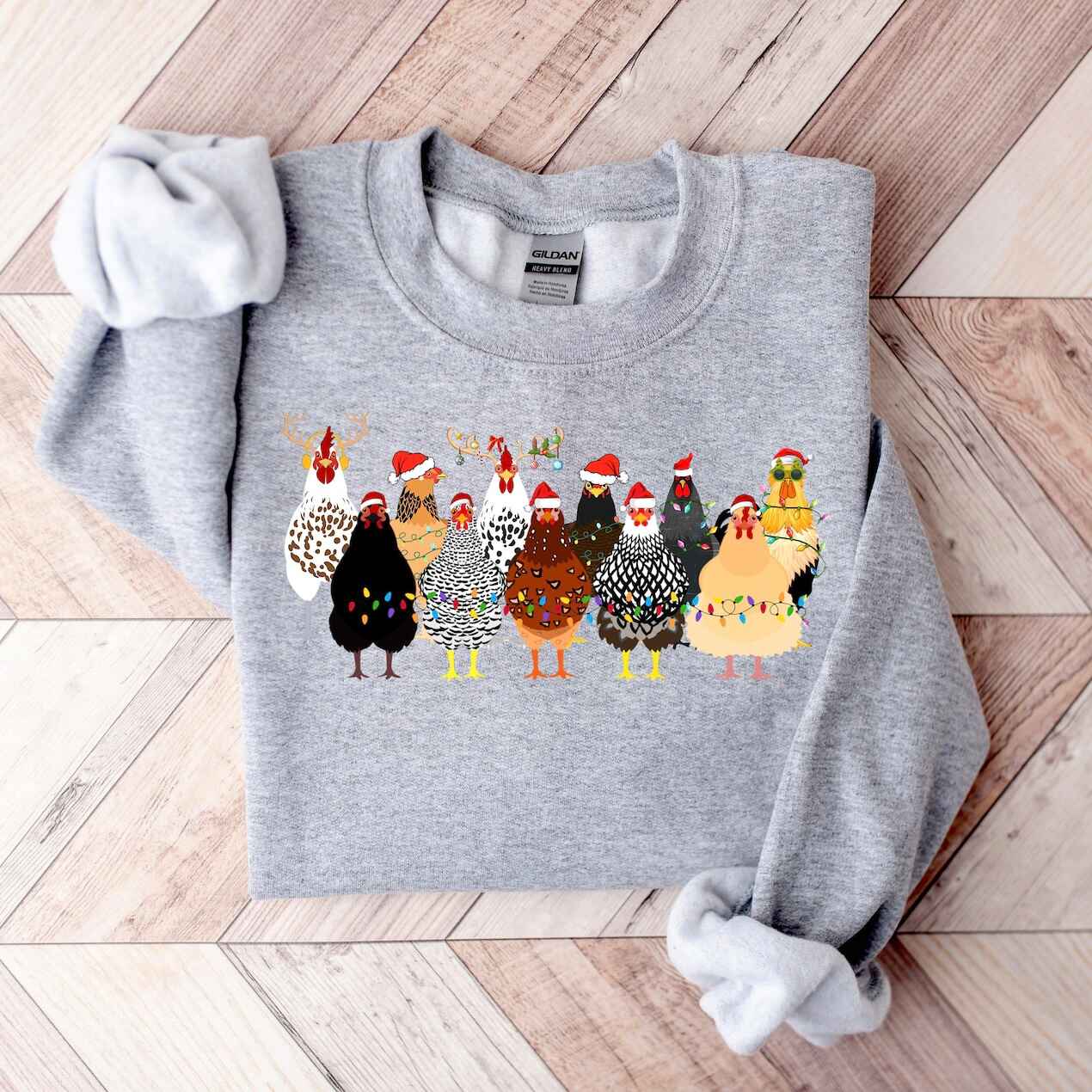 Cozy holiday sweatshirt featuring colorful chickens in Christmas hats
