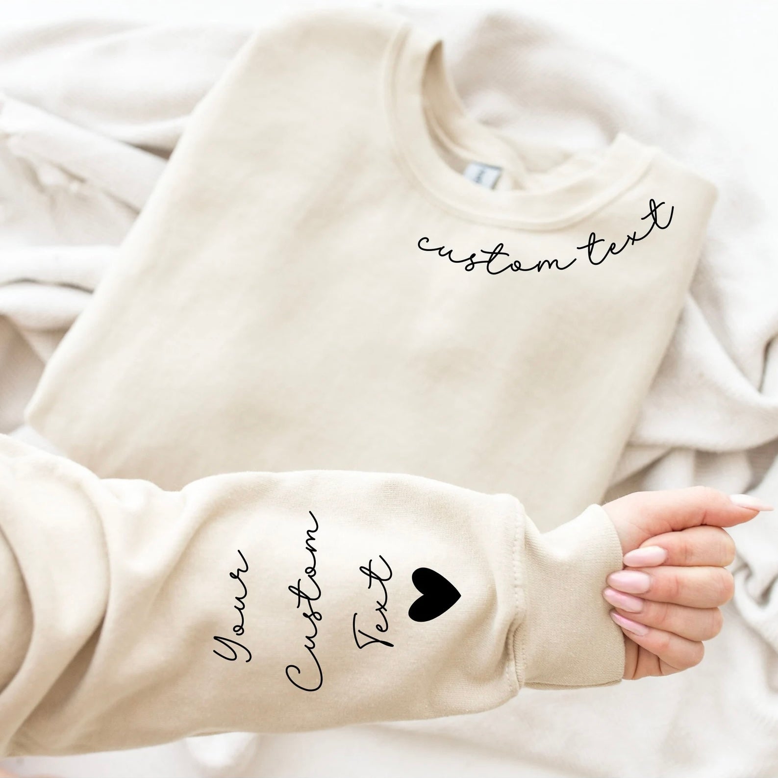 Personalized sweatshirt with custom text design on neckline and sleeves for gifting.