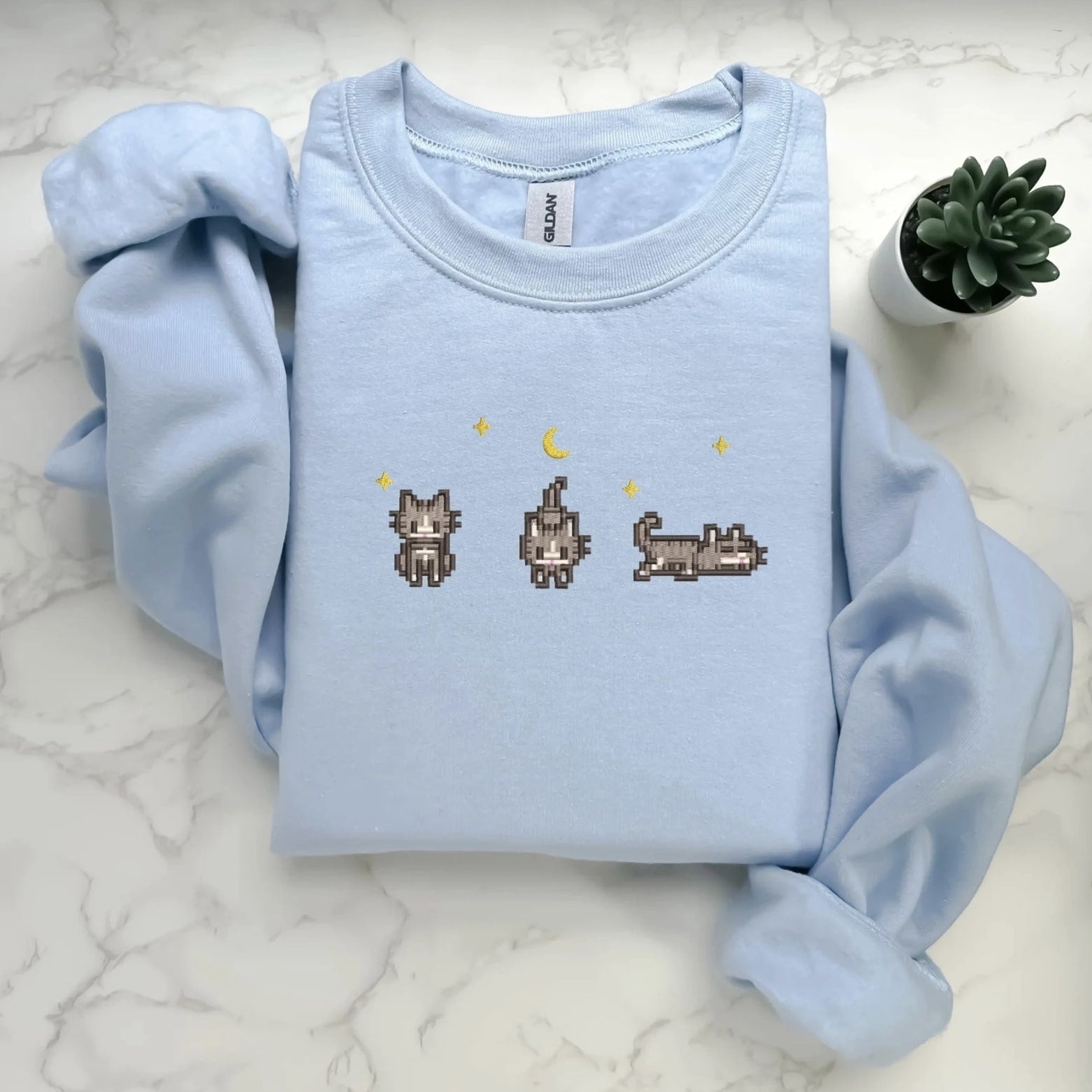 Cozy sweatshirt featuring retro-style cat designs for gaming enthusiasts.