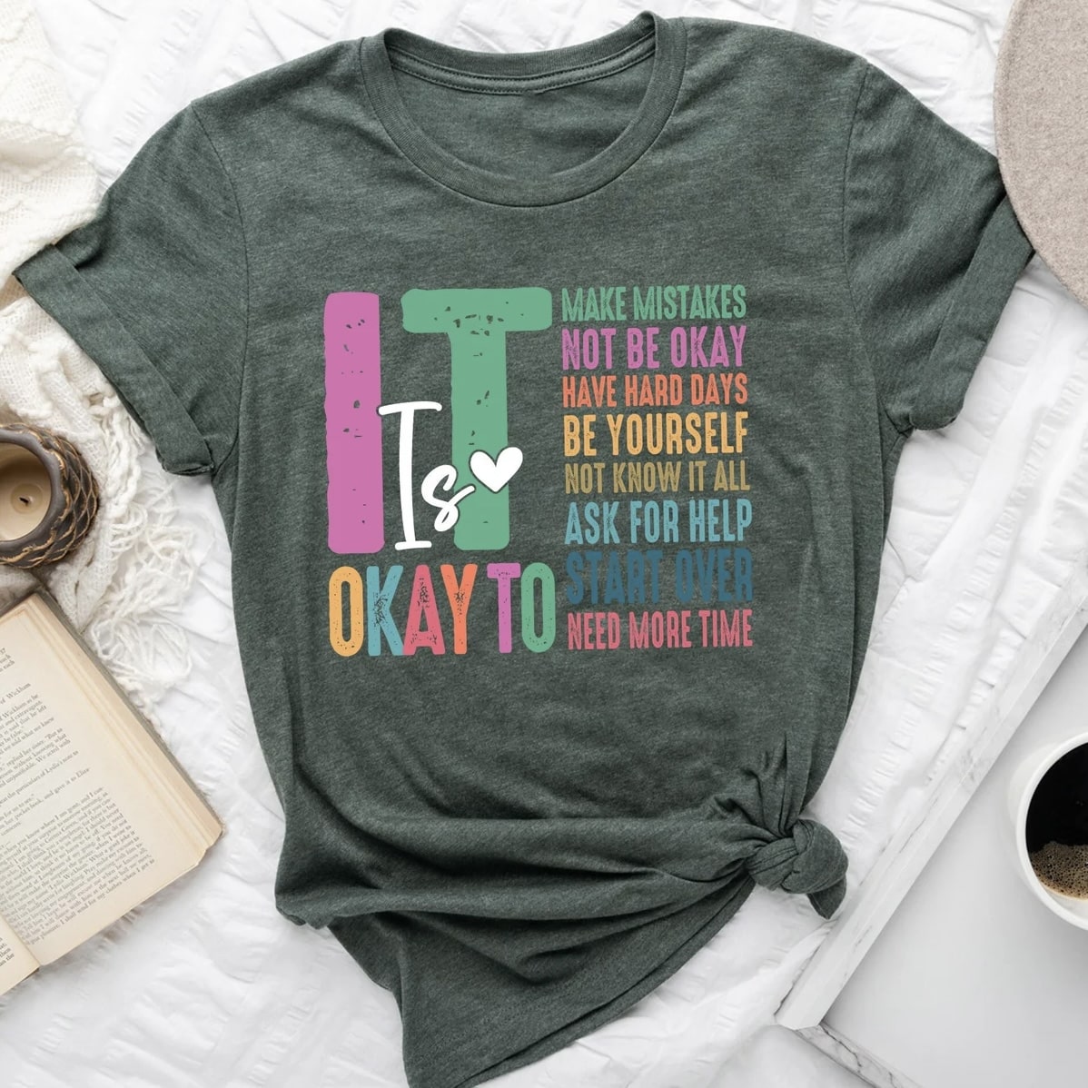 Sweatshirt with motivational "It's Okay" quote surrounded by colorful hearts.