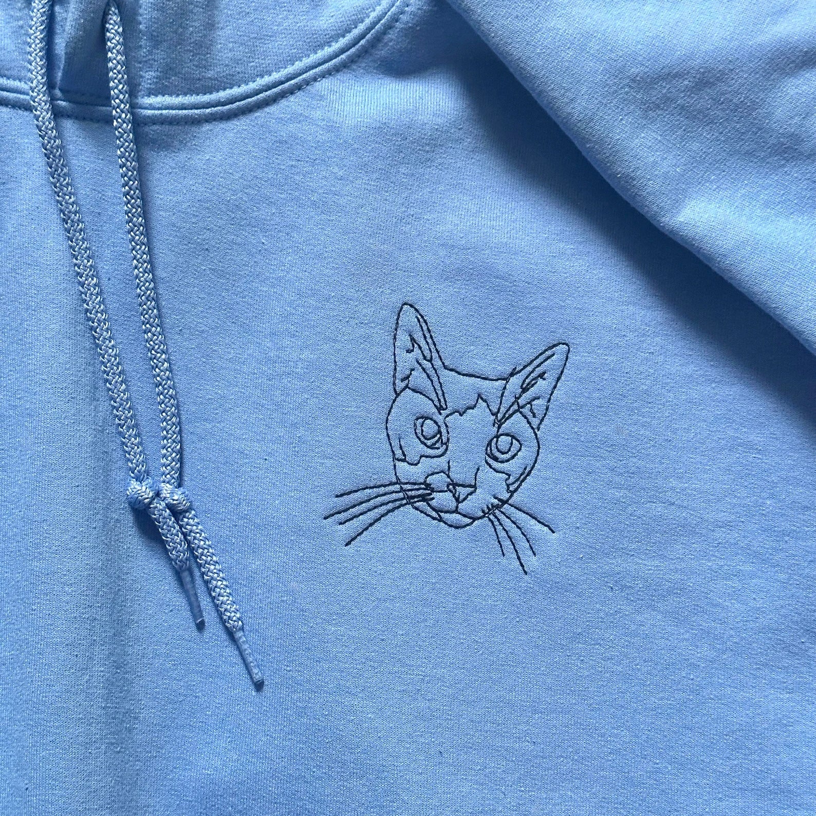 Unique gray hoodie featuring custom embroidered dog illustration