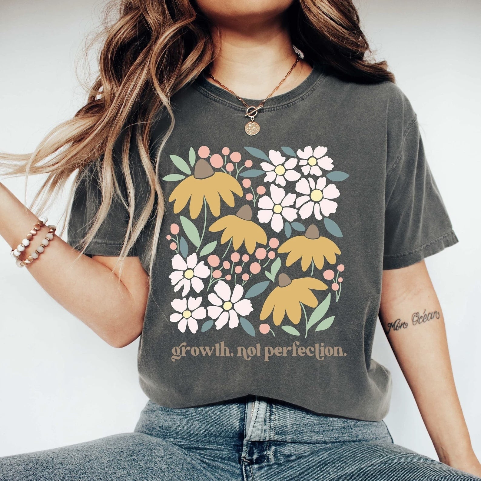 Close-up of the "Growth, Not Perfection" floral graphic tee