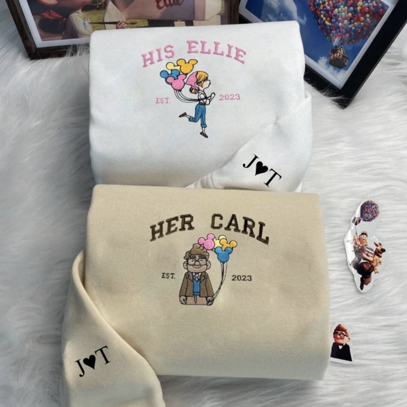 Matching white and beige couple hoodies featuring Ellie and Carl inspired embroidery.