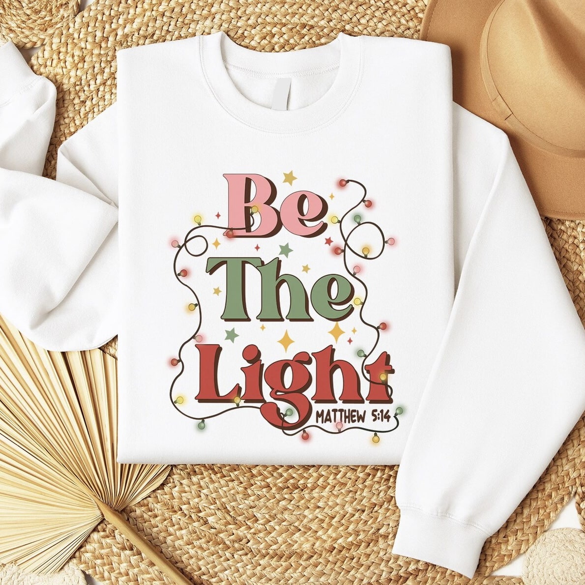 Soft and cozy Christmas sweatshirt with colorful lights and inspiring faith-based design.