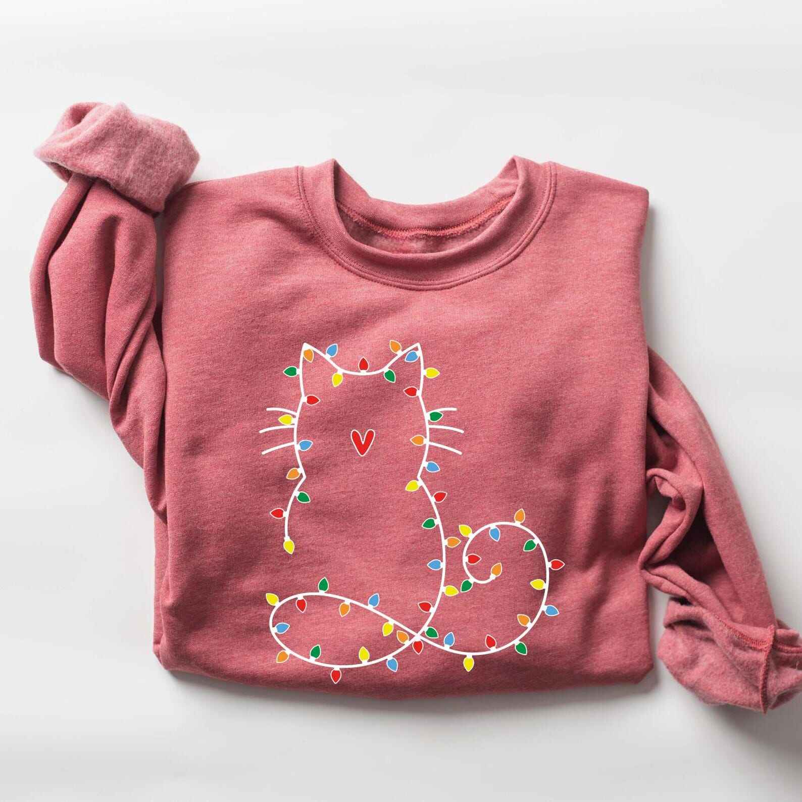 Festive holiday sweatshirt featuring a cute cat design with Christmas lights
