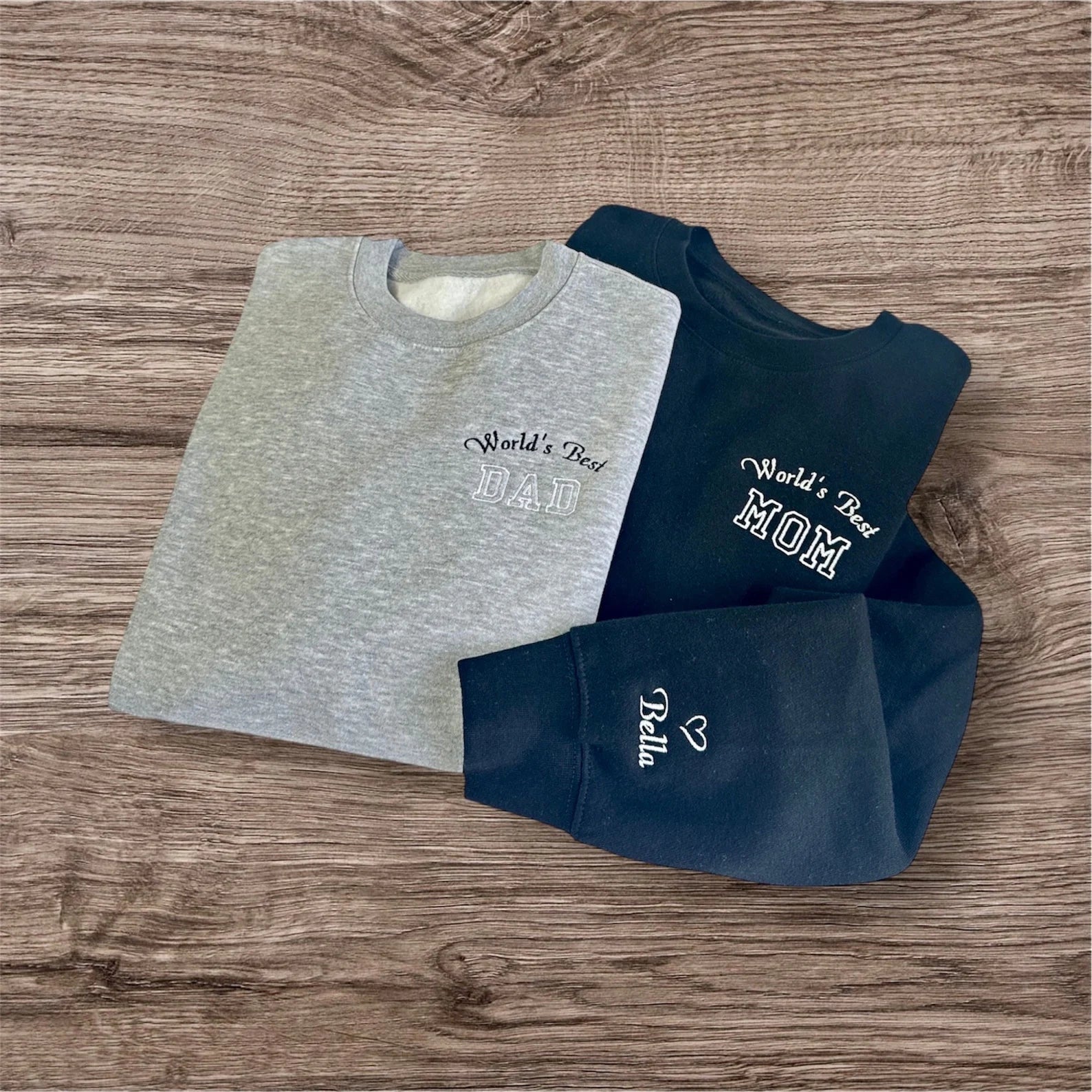 Personalized family sweatshirts featuring embroidered text and custom names.