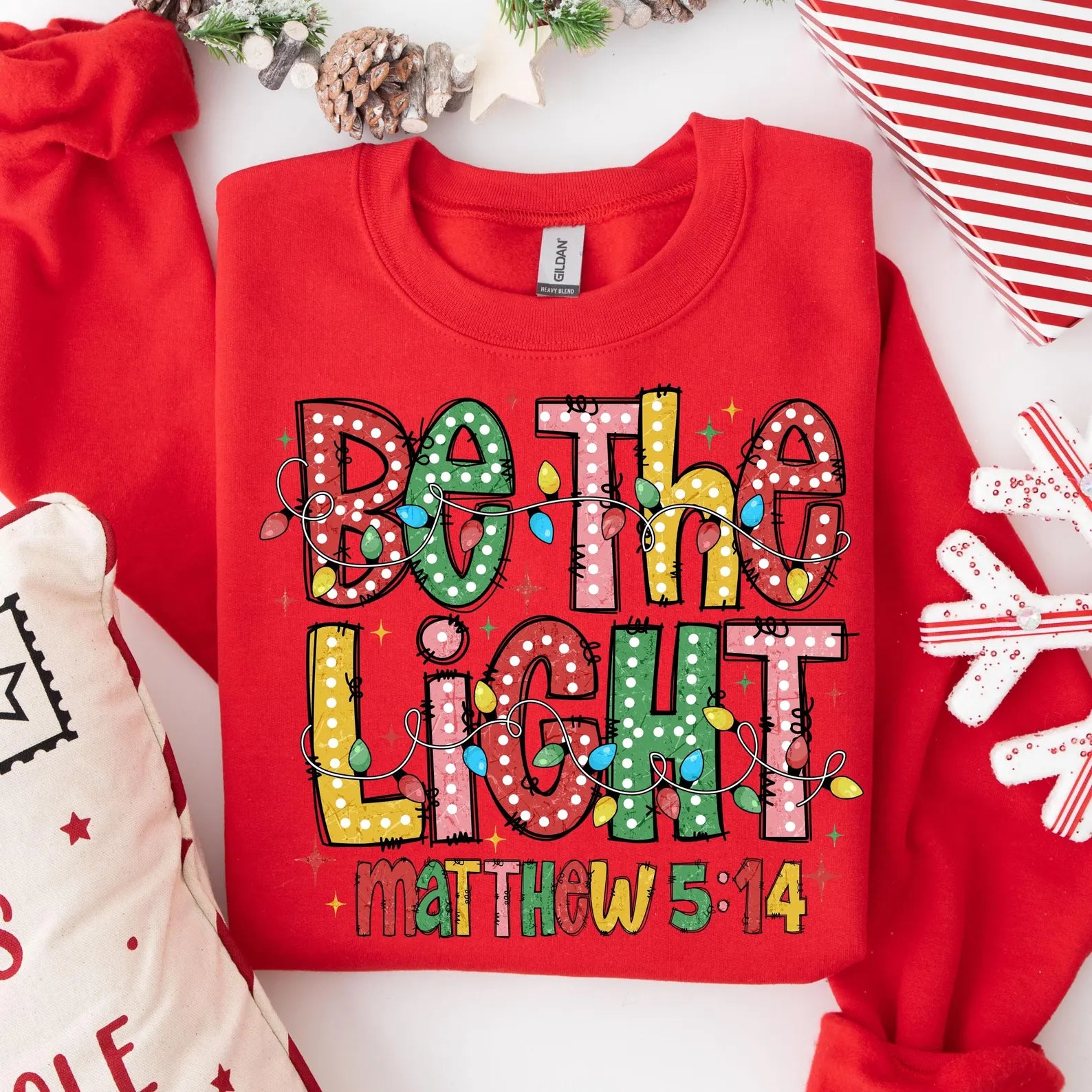 Be The Light Matthew 5:14 Christmas sweatshirt with colorful lights and Bible verse design.