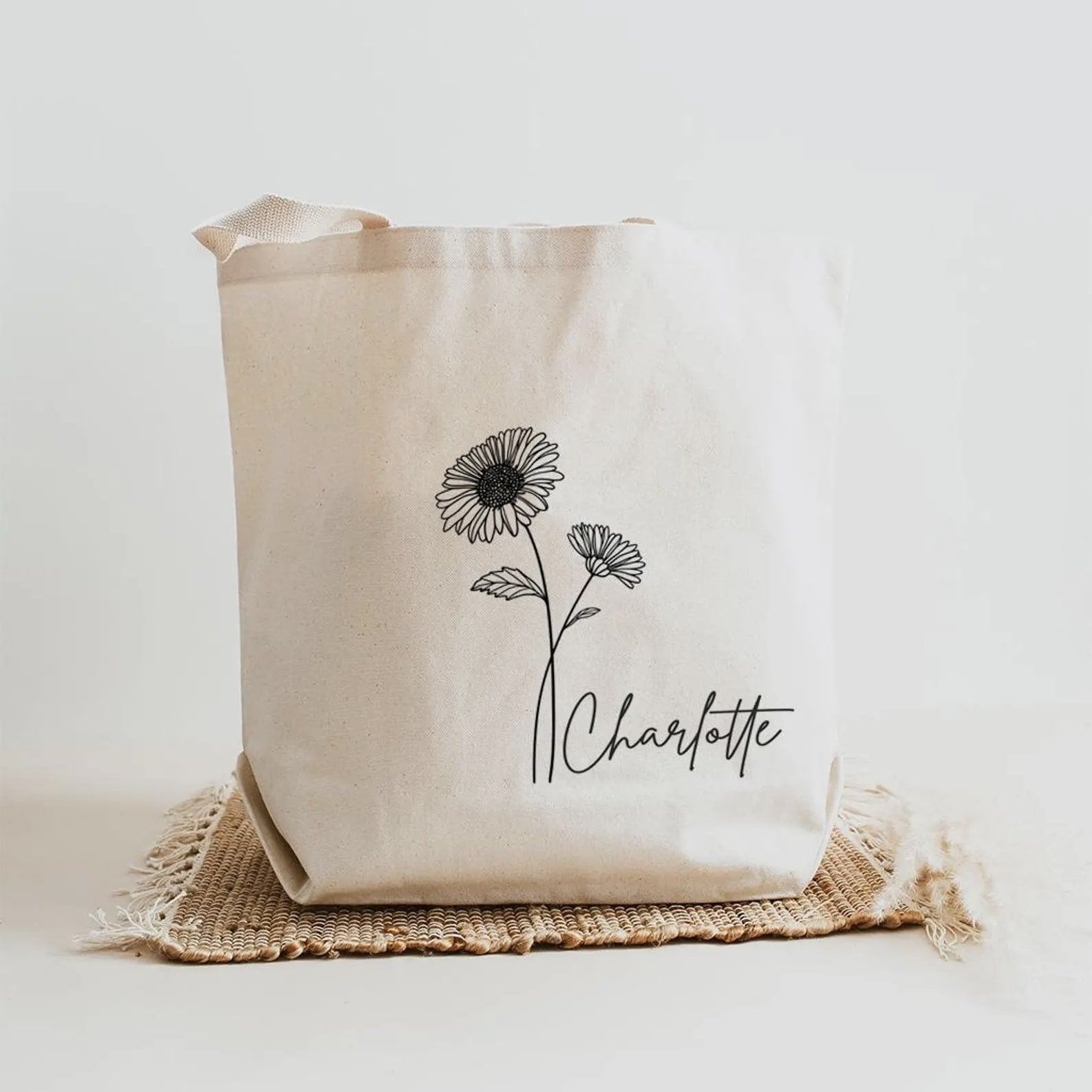 Eco-friendly canvas tote featuring birth month flower and name customization.