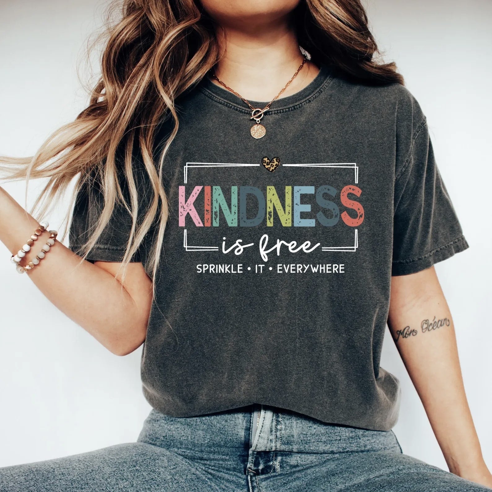 "Kindness is Free" sweatshirt in red with colorful design.
