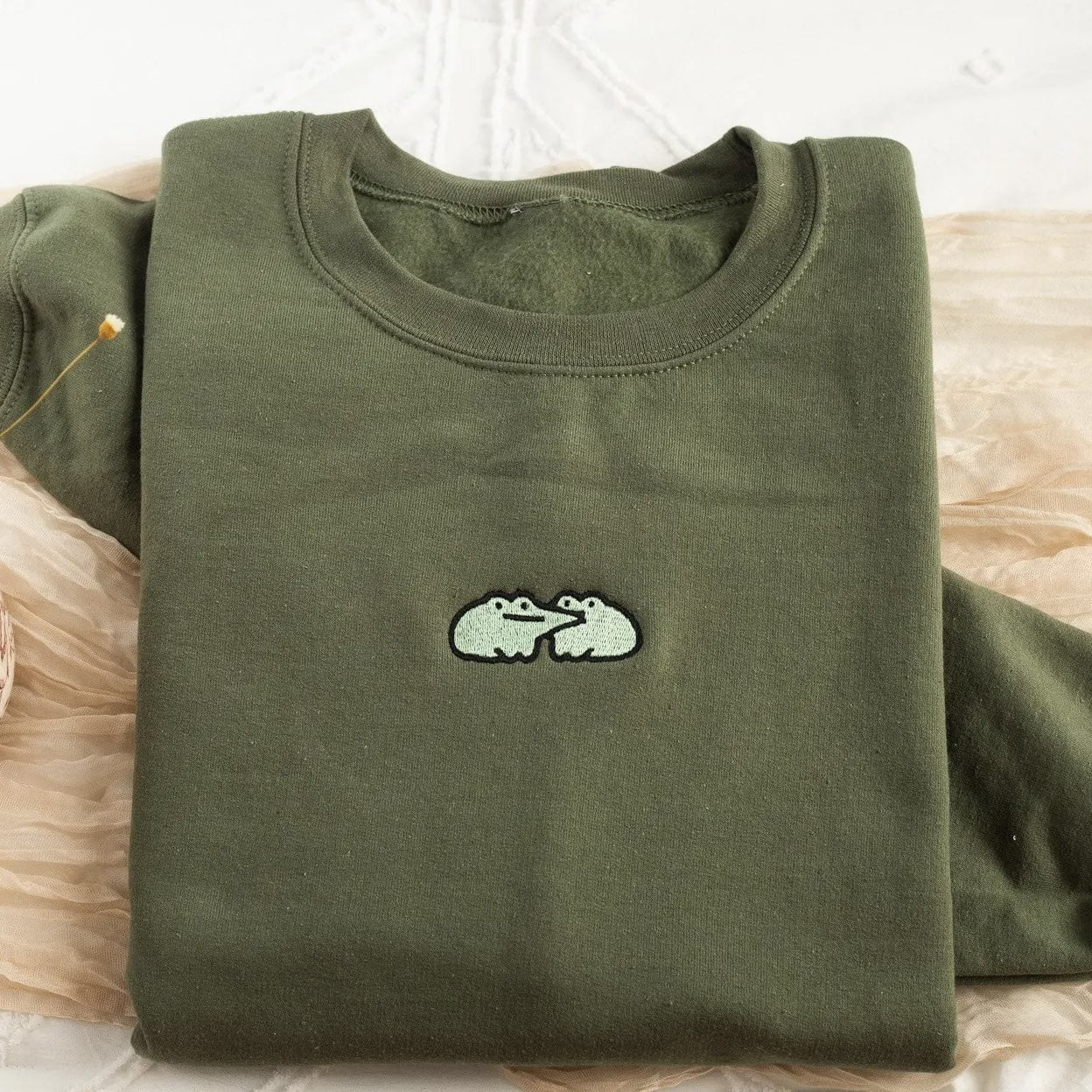 Durable cotton crewneck featuring playful frog embroidery