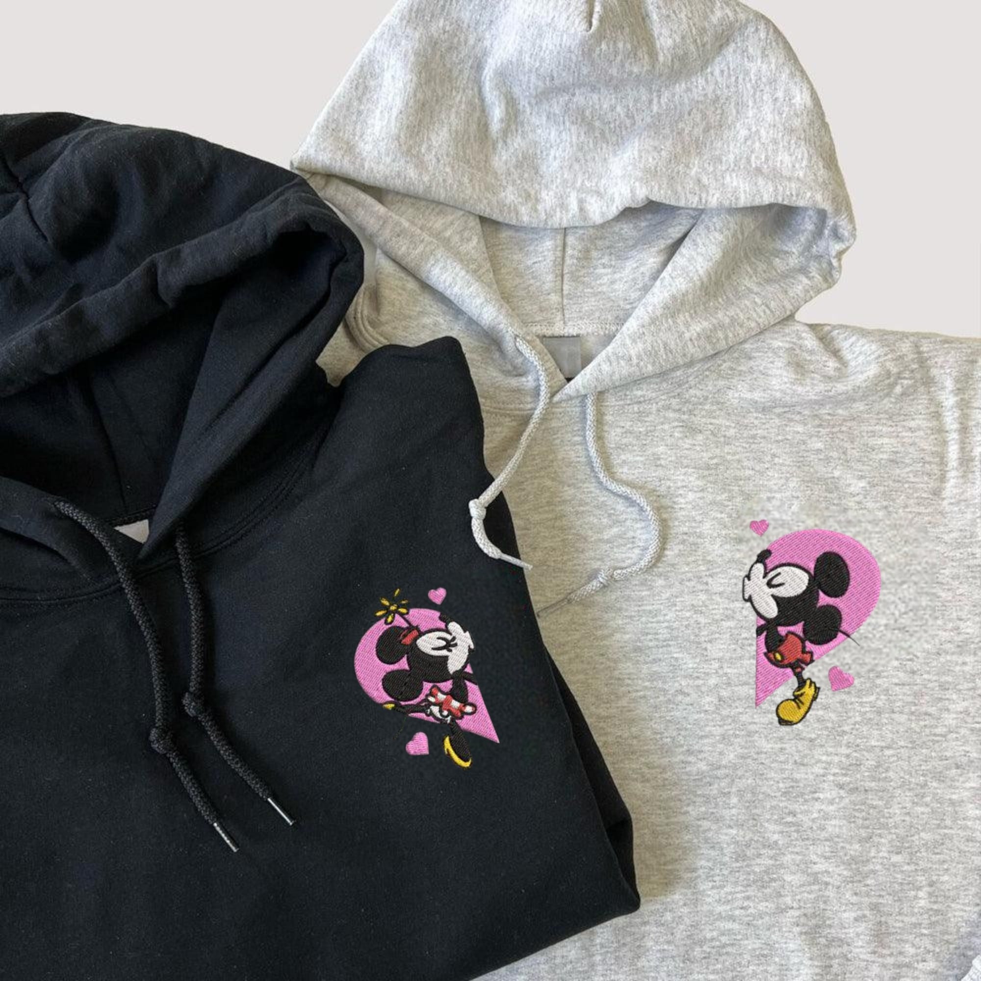 Mickey and Minnie embroidered couple hoodies with split heart design.

