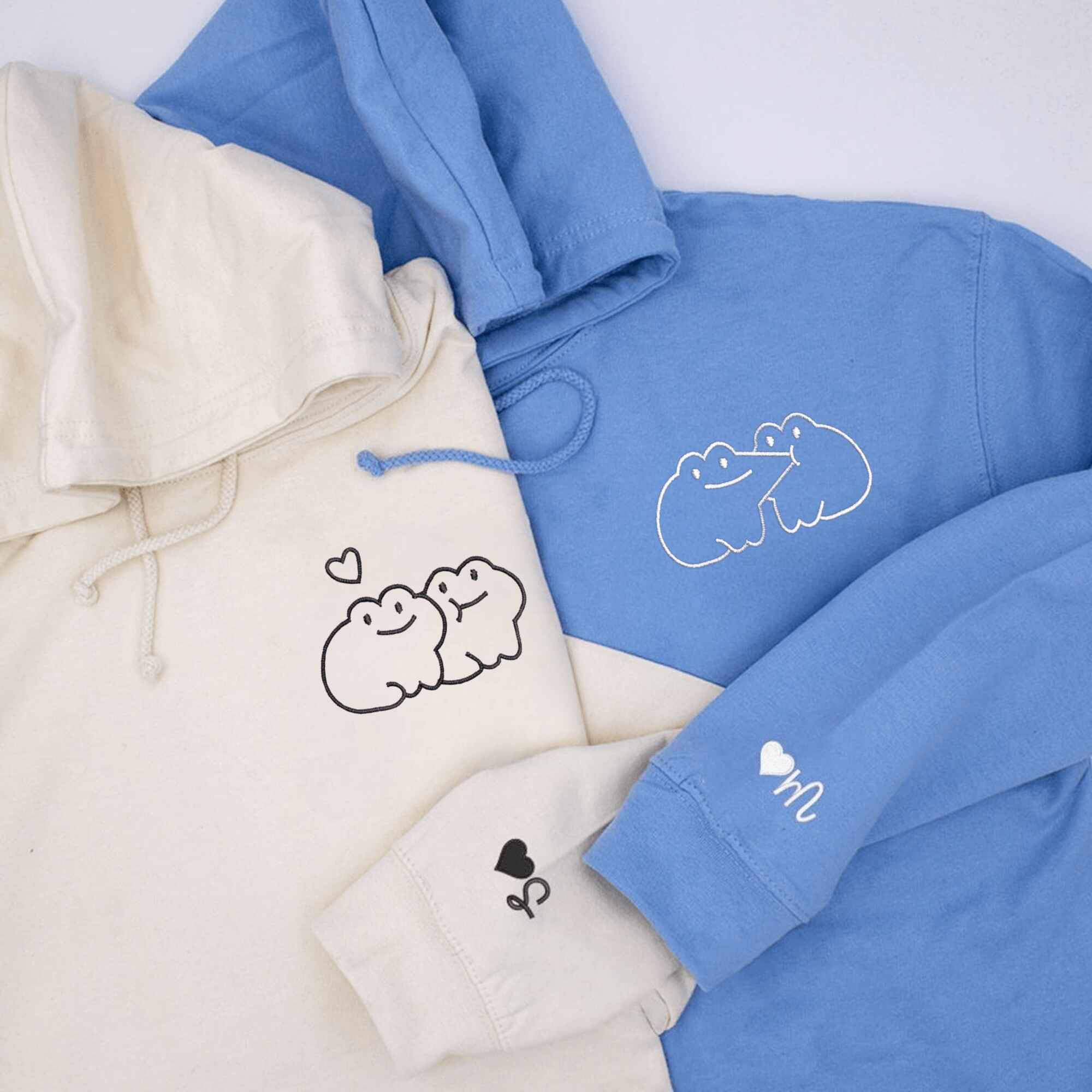 Matching Couple Hoodies with custom embroidered matching couple sweatshirts showcasing a playful frog kiss.
