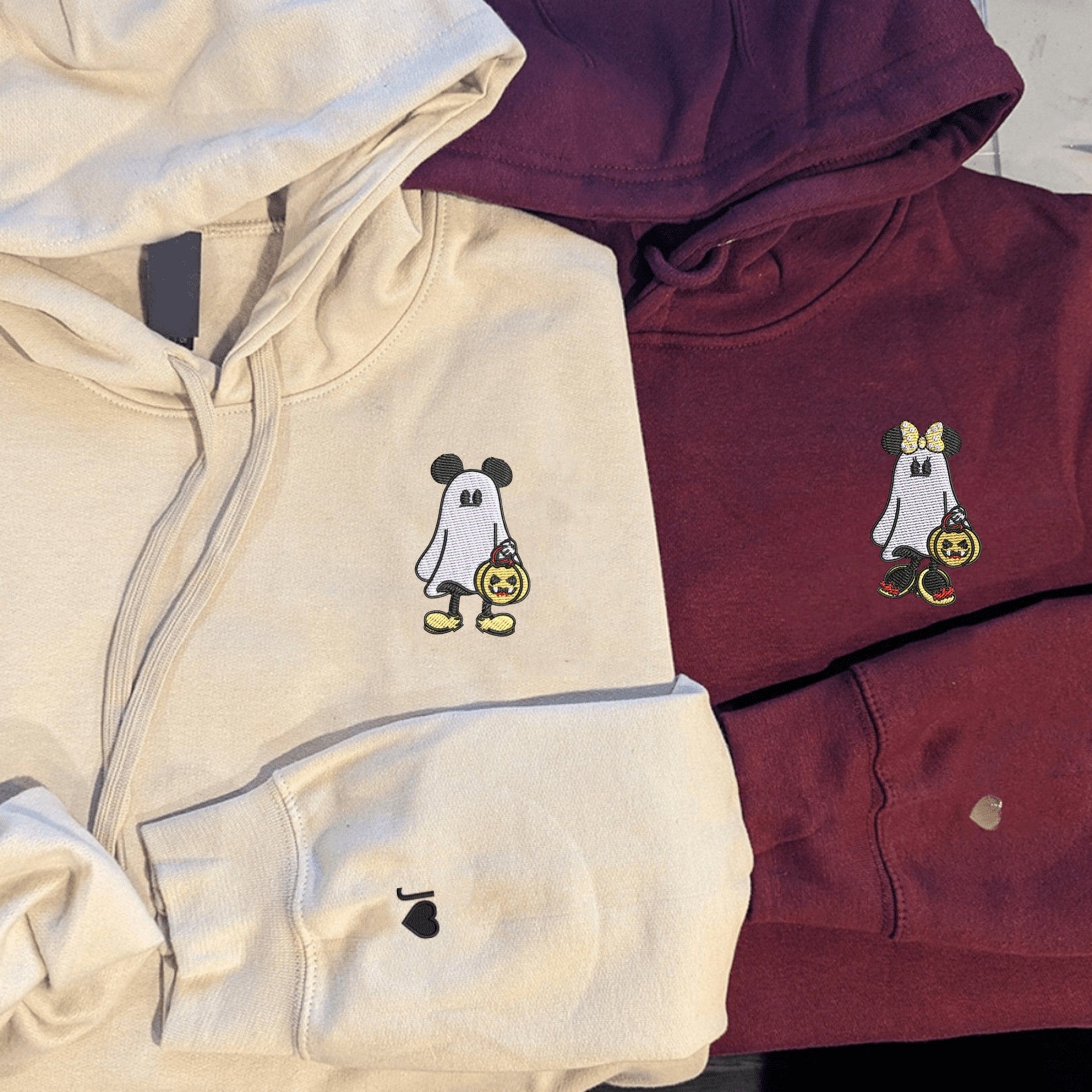 Matching Ghost Mouse couple hoodies with pumpkin trick-or-treat designs

