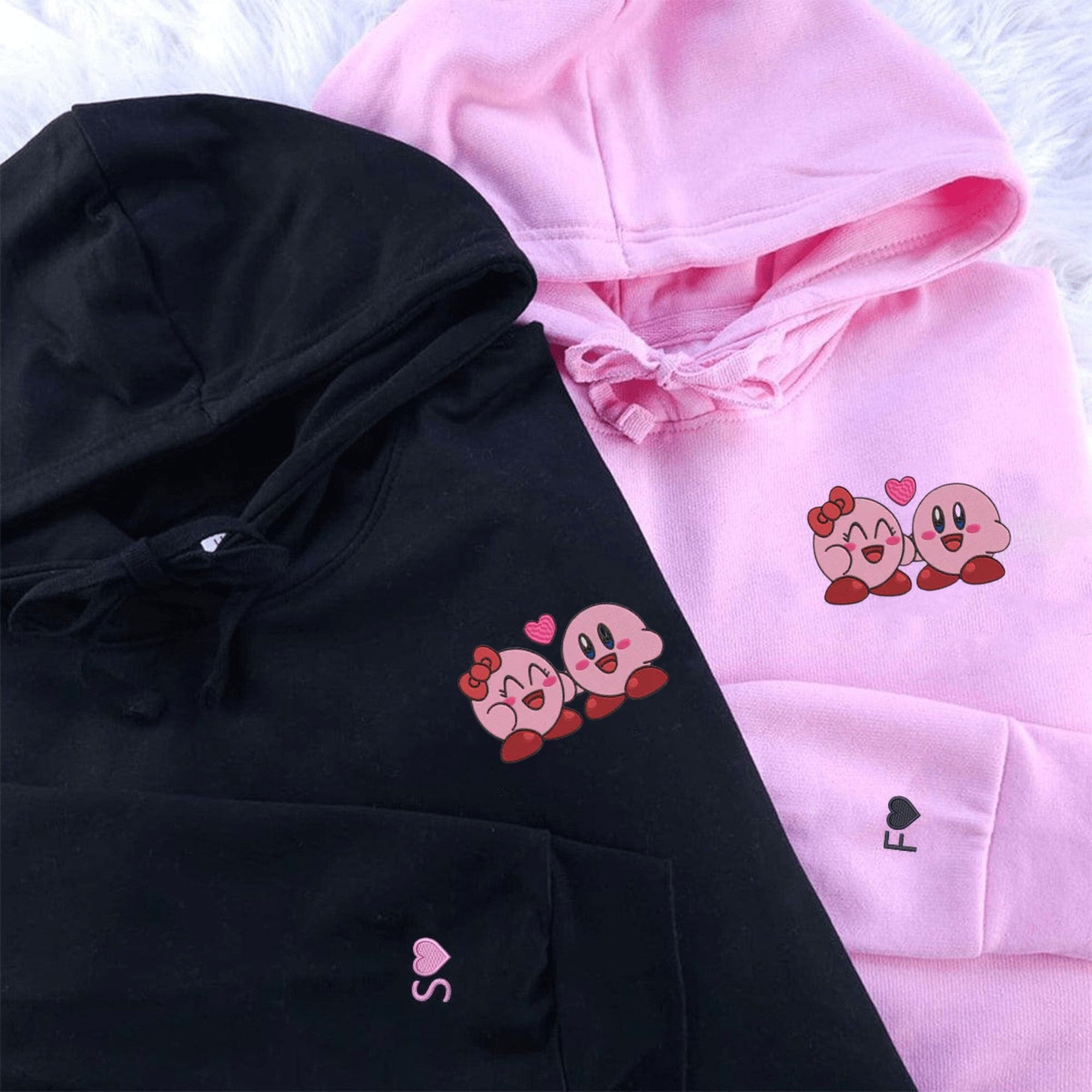 Matching Kirby couple hoodies in black and pink with cute Kirby designs.

