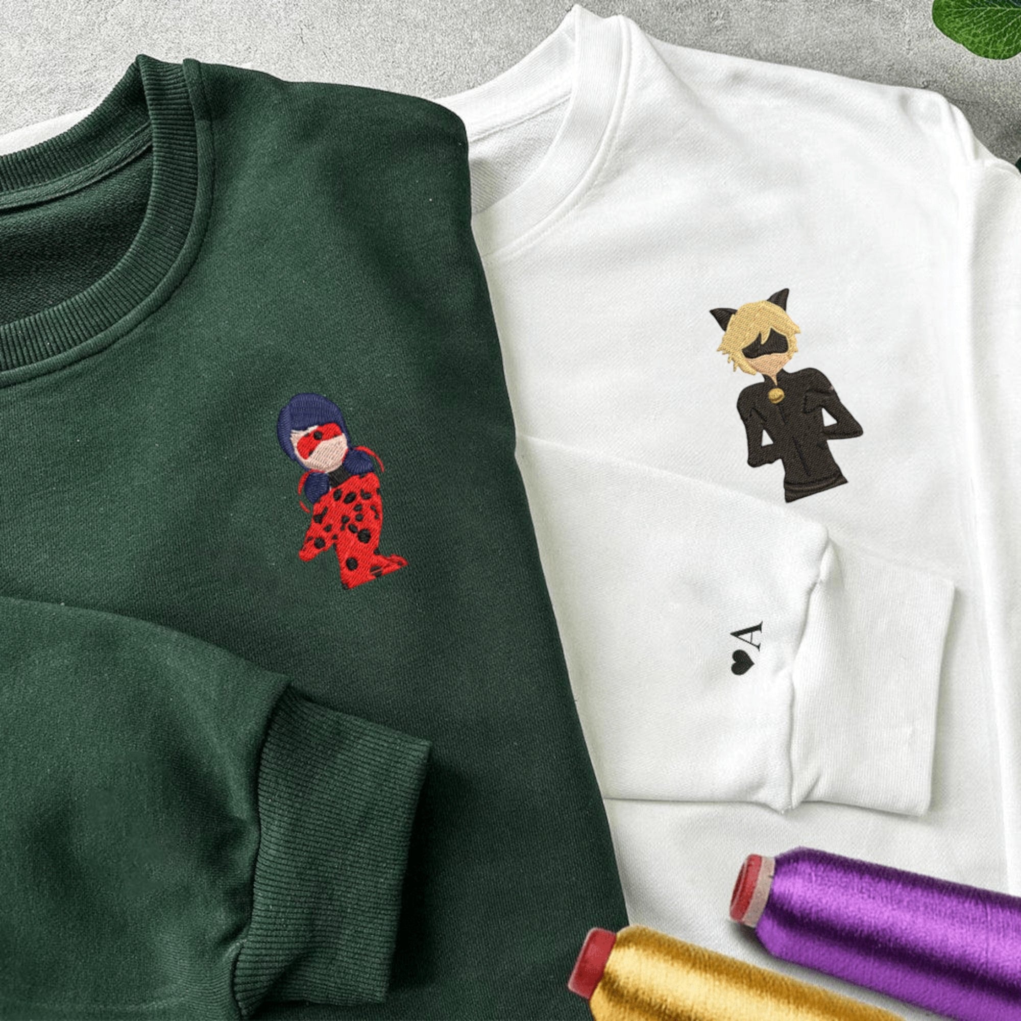 Matching Miraculous Ladybug and Cat Noir couple hoodies with embroidered designs.

