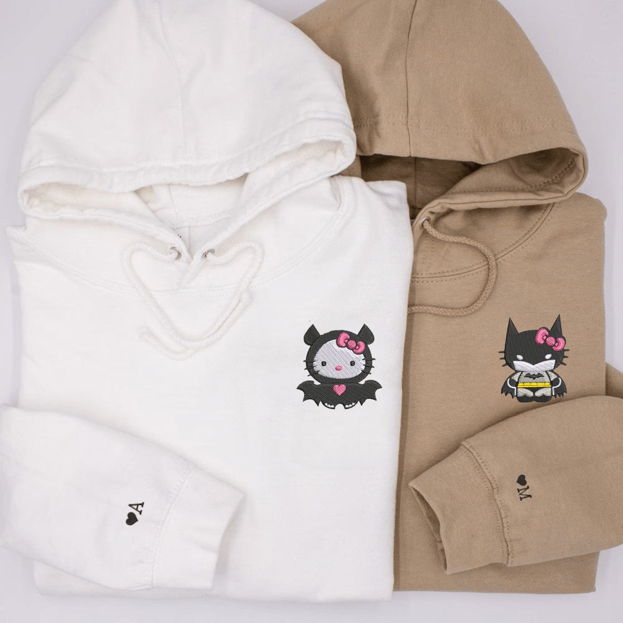 Adorable Hello Kitty Bat couple hoodies in white and beige, perfect for couples.

