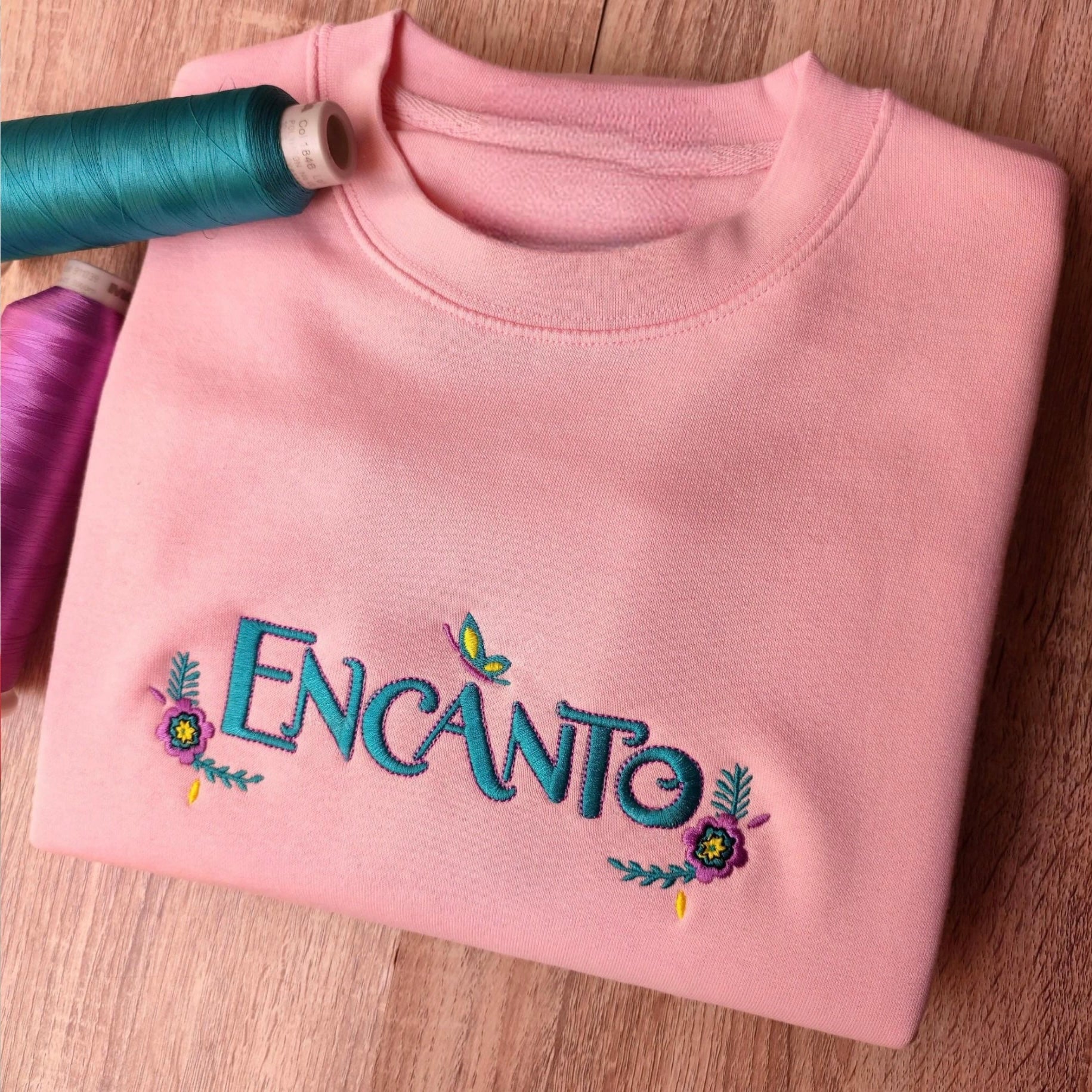 Custom embroidered graphic meme shirts featuring a vibrant "Encanto" design, ideal for best gag gifts for men.
