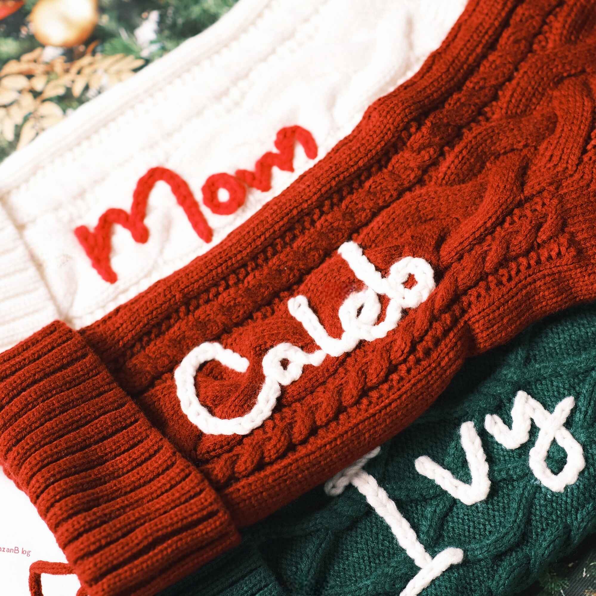 Personalized Christmas stockings with custom names in red, green, and cream
