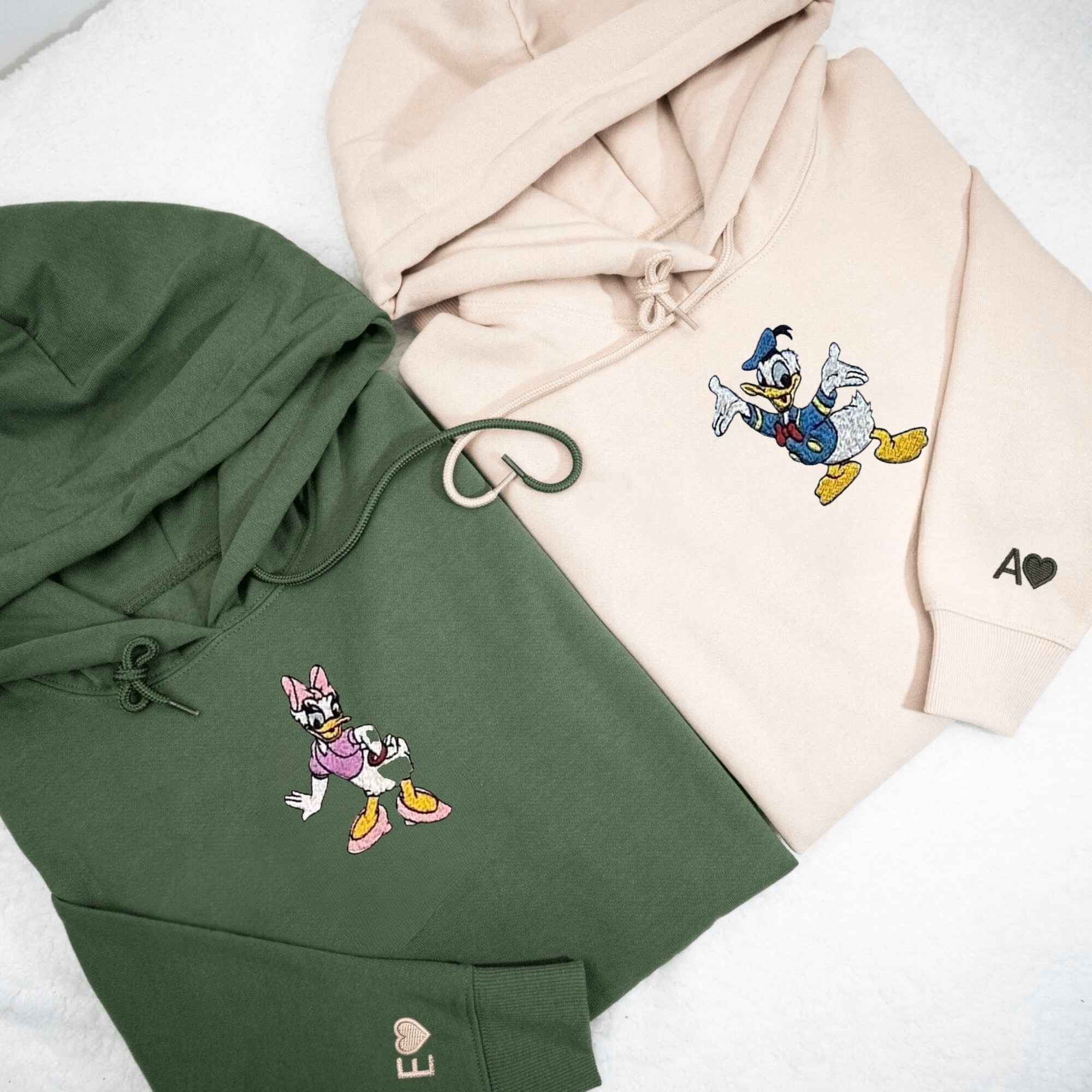 Matching Couple Hoodies with custom embroidered matching couple sweatshirts showcasing Donald and Daisy motifs.
