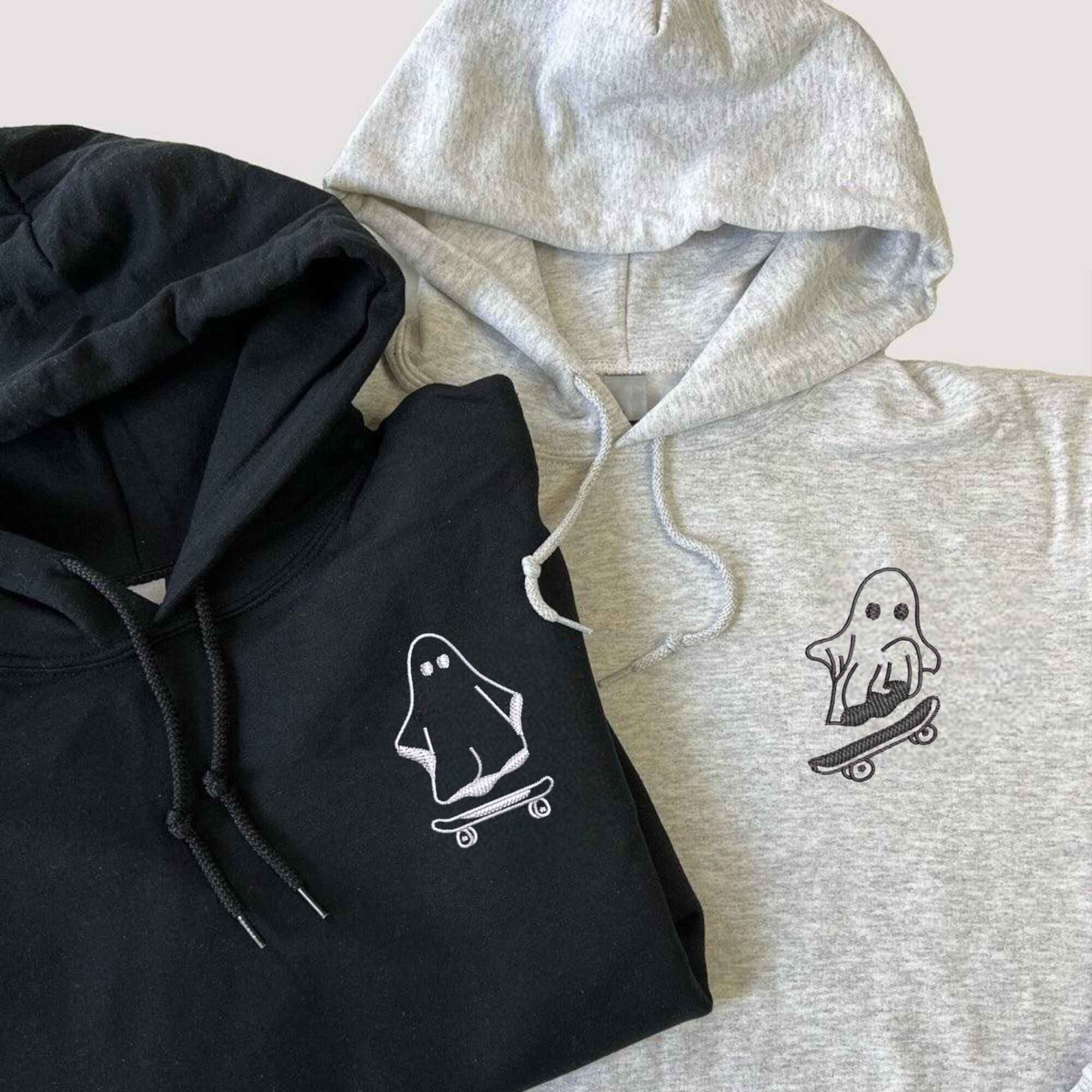 Matching couple hoodies featuring playful skating ghost designs.
