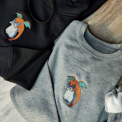 Custom embroidered graphic meme shirts featuring two creatures hugging, capturing the essence of a t-shirt meme in a fun design.
